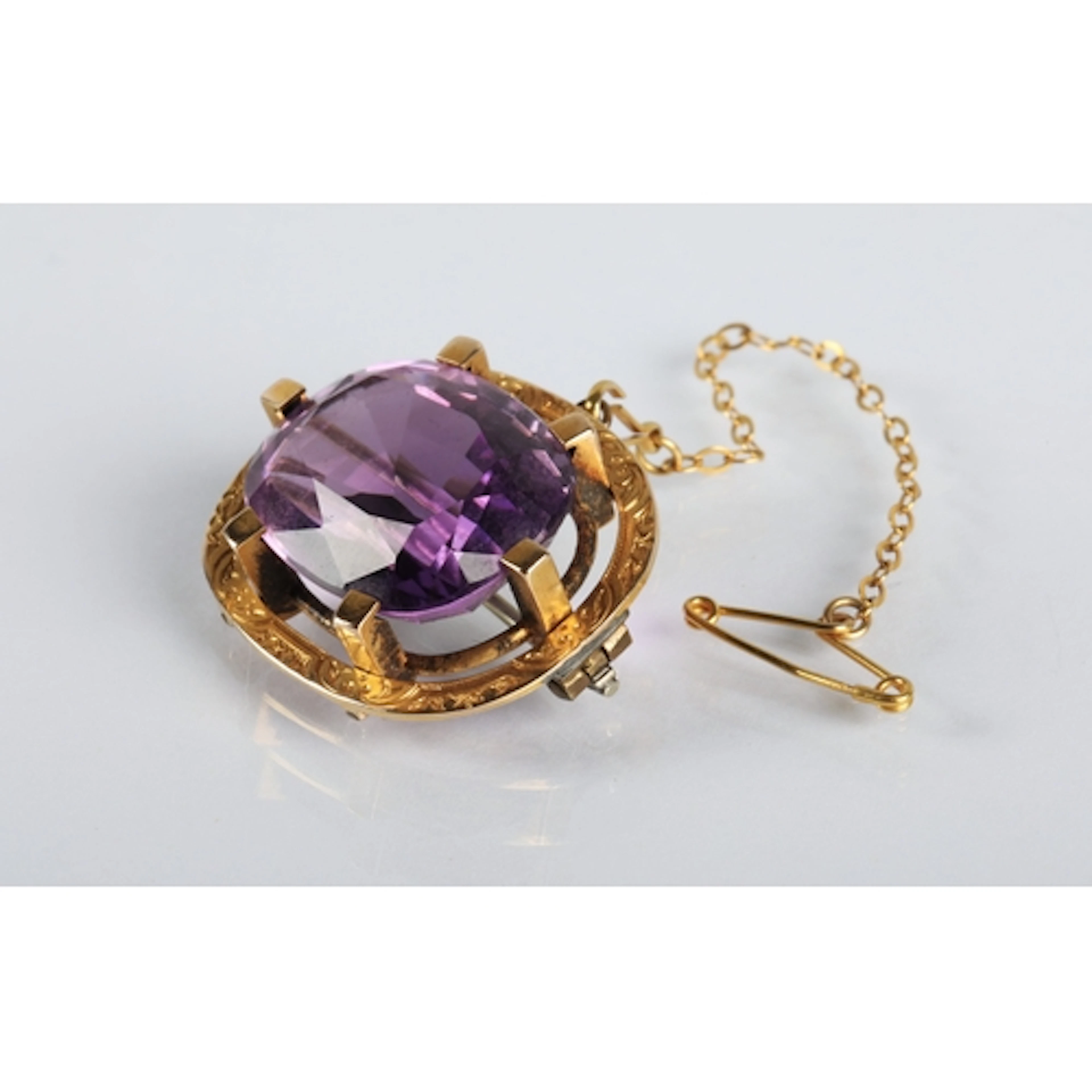 Yellow metal mounted amethyst brooch