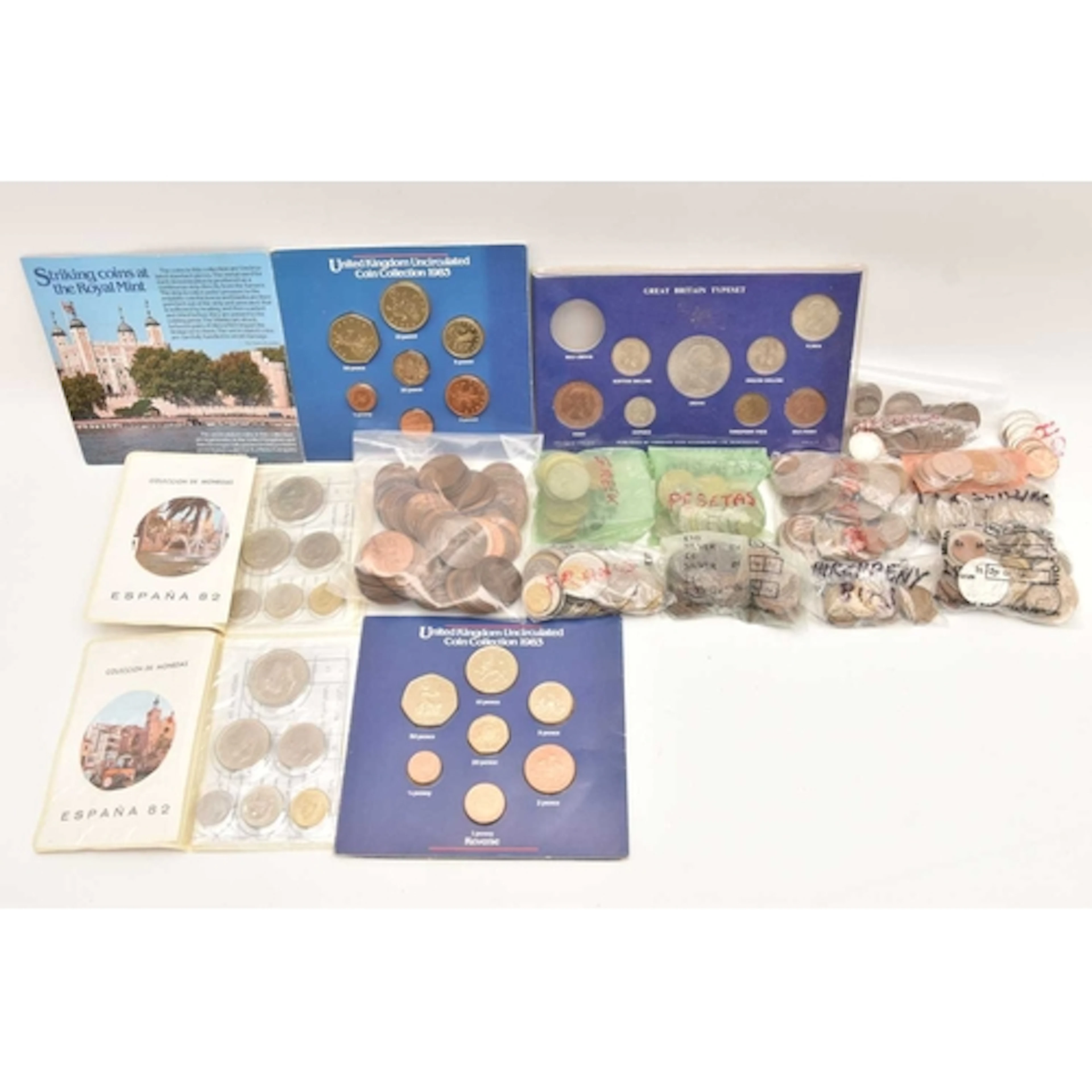A small collection of coins contained in a sweet box. There ...