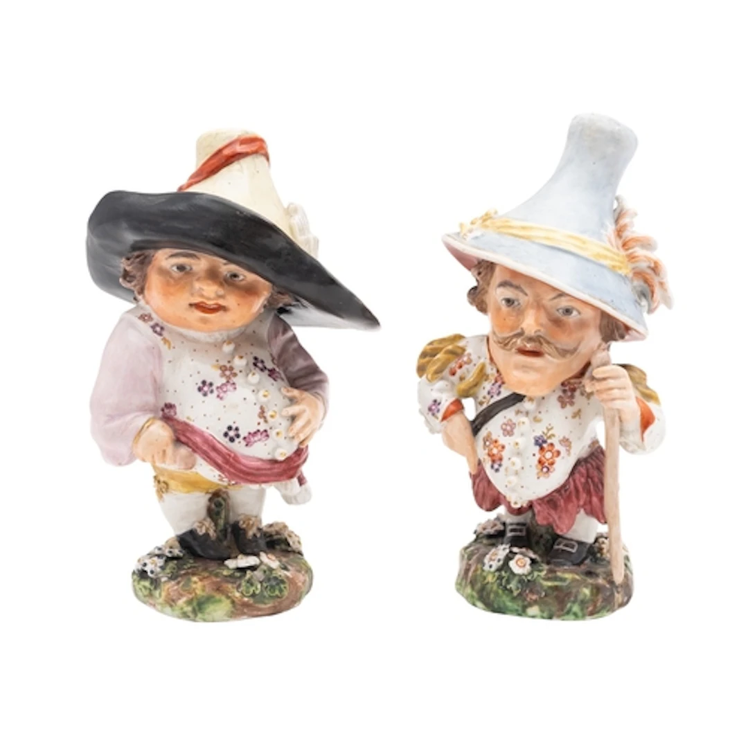 A pair of Derby Mansion House dwarfs, circa 1790-1800 wearin...