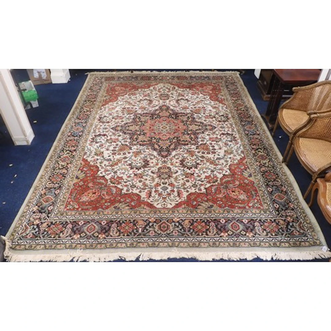 A cream ground Louis de Poortere "Kadjar" rug with multicolo...