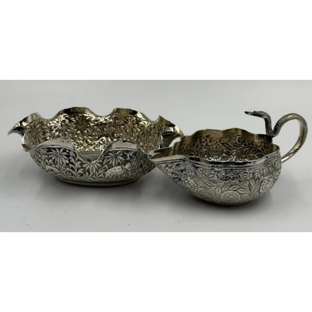 Two items of Indian silver to include a snake themed jug and...