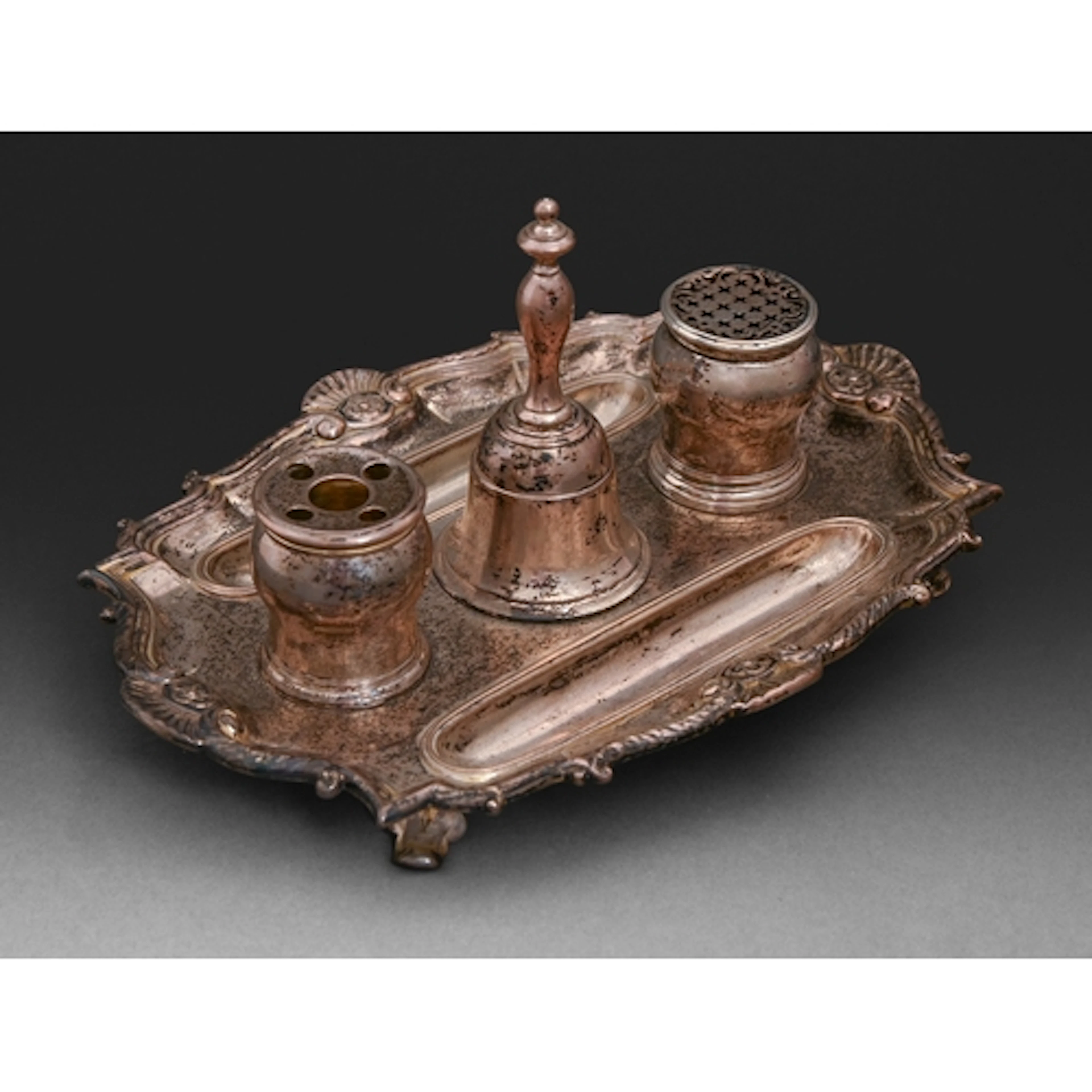 A George II rococo silver inkstand, with four shells to the ...