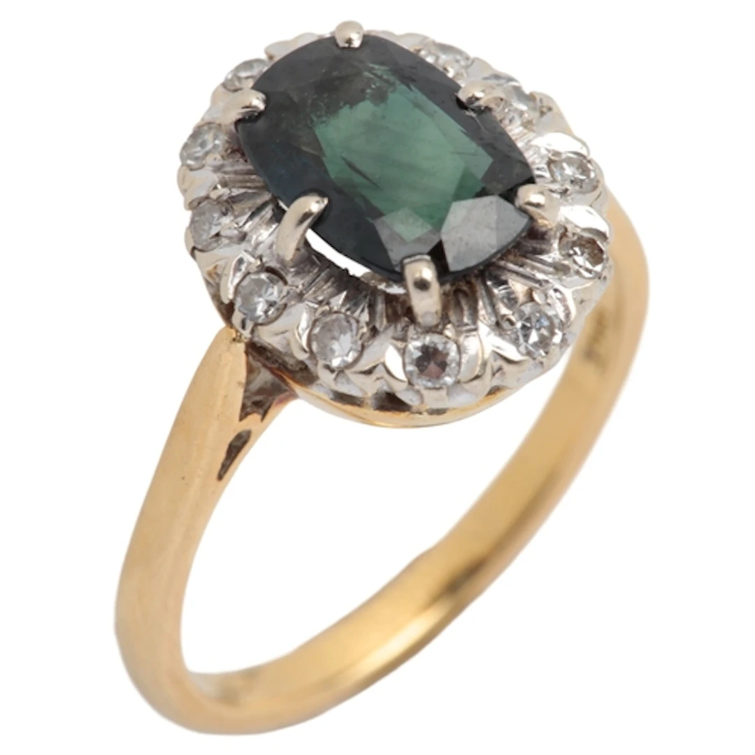 An 18ct, sapphire and diamo9nd set oval cluster ring, size O...