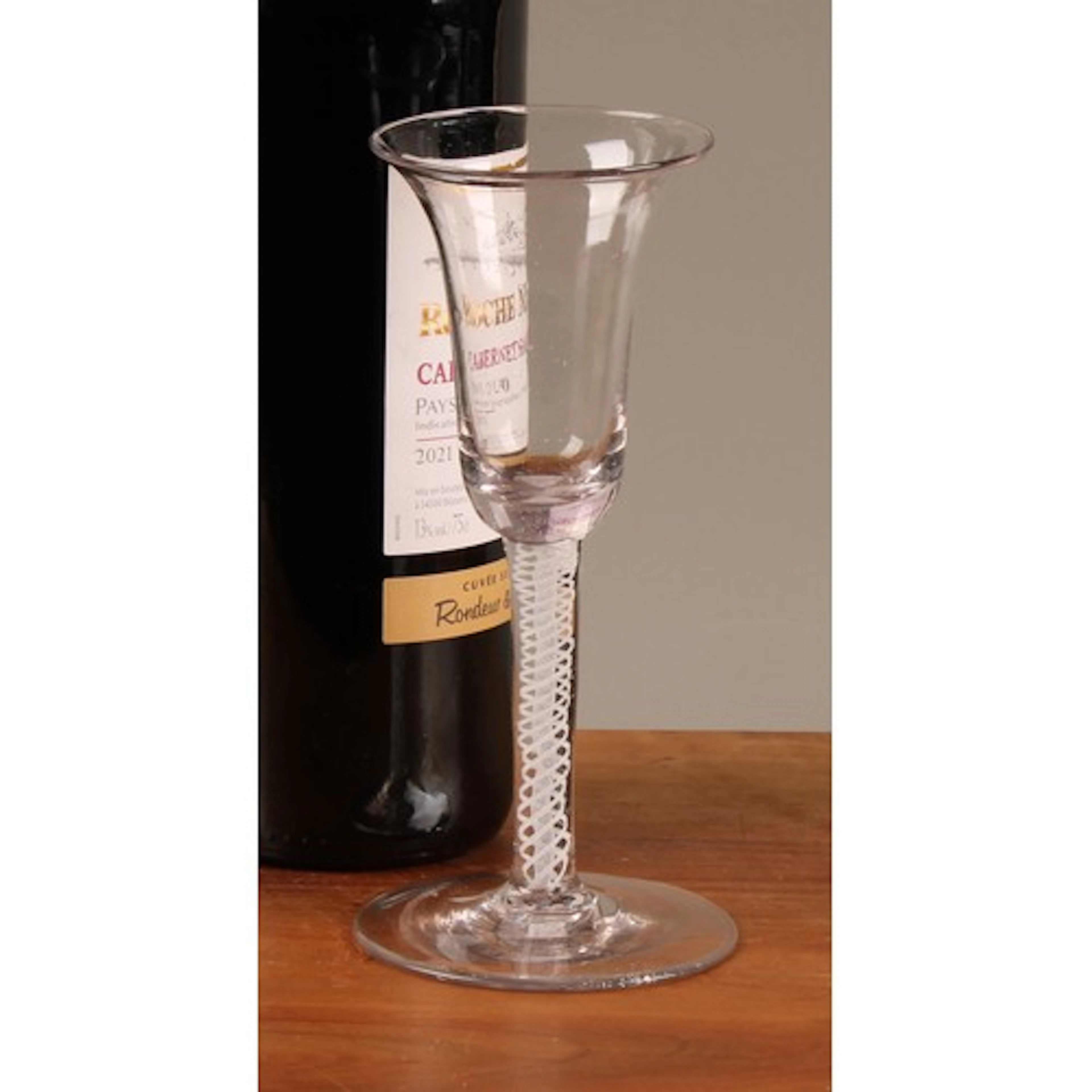 A George III opaque twist wine glass, bell shaped bowl, doub...