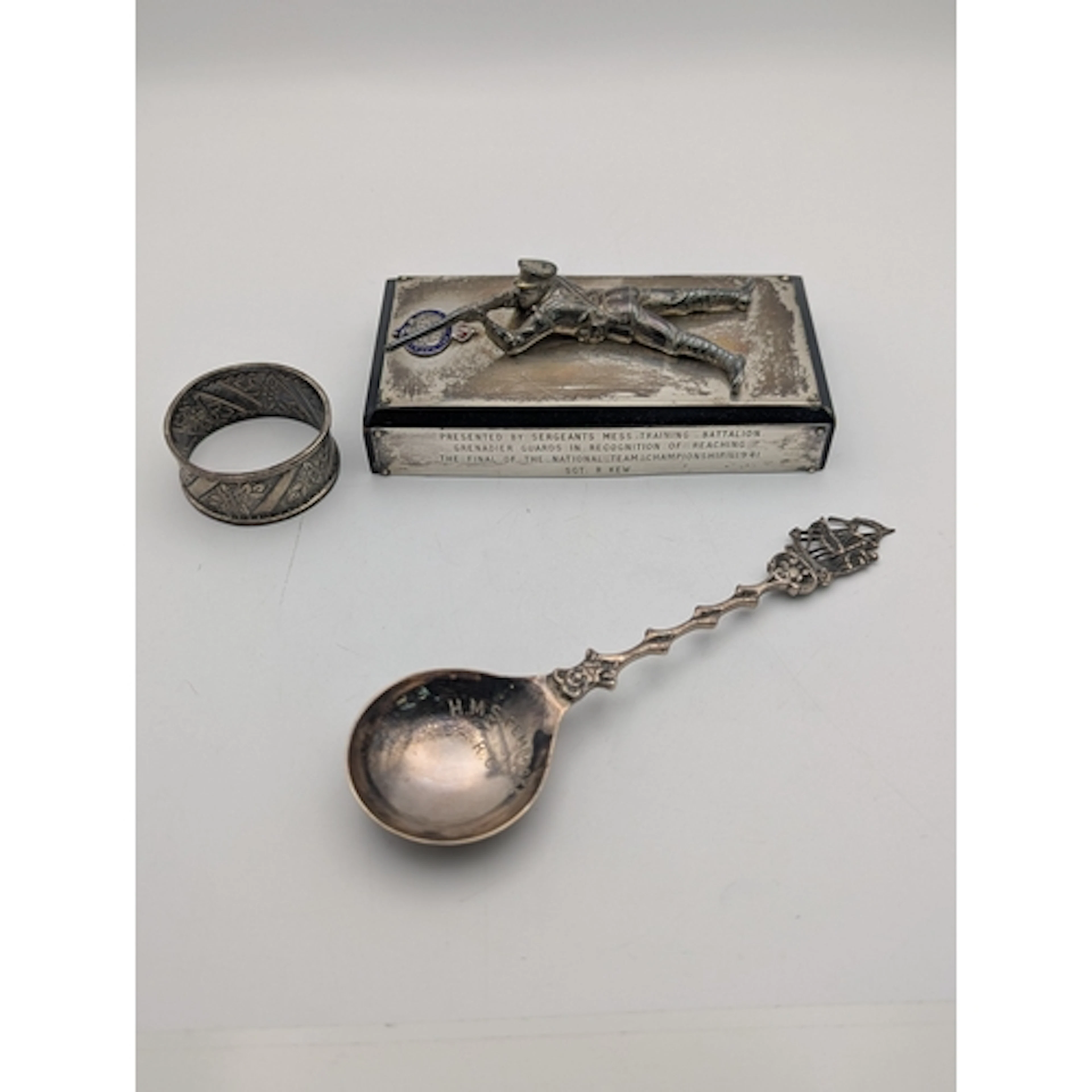 A group of silver items to include a shite metal trophy pres...