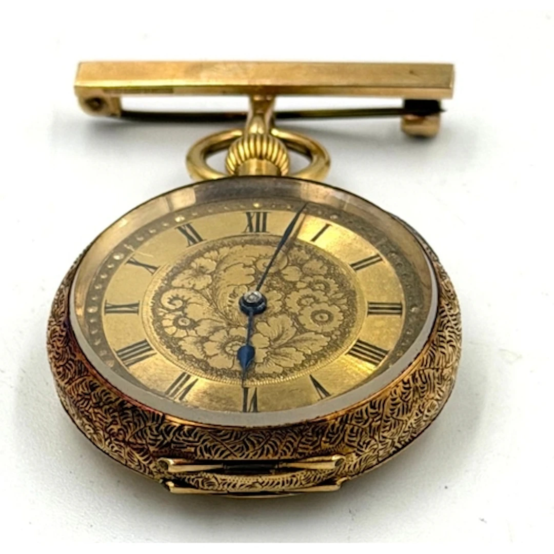 An 18ct gold Ladies fob watch with ornate decoration and set...