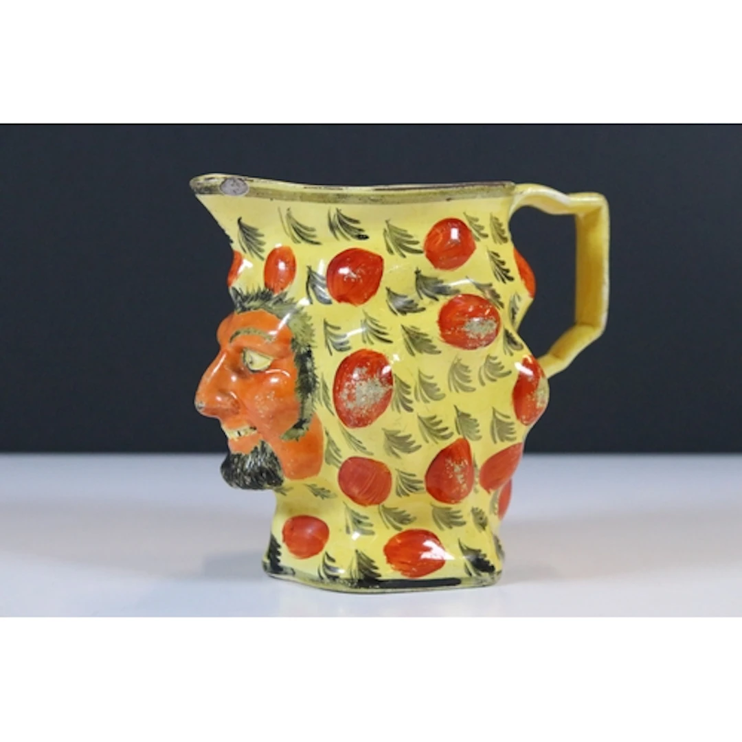 19th century Staffordshire pottery Satyr mask jug, on canary...