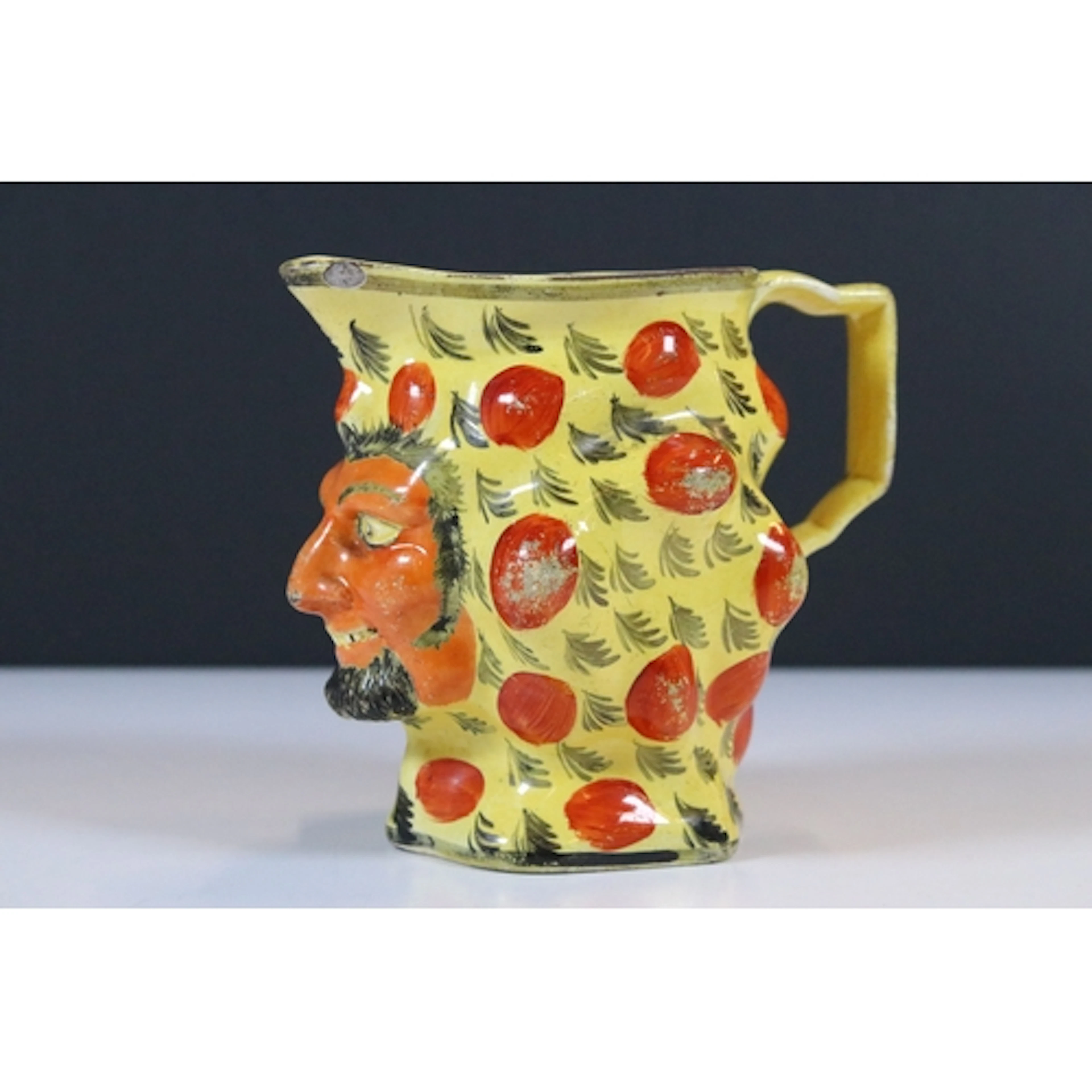 19th century Staffordshire pottery Satyr mask jug, on canary...