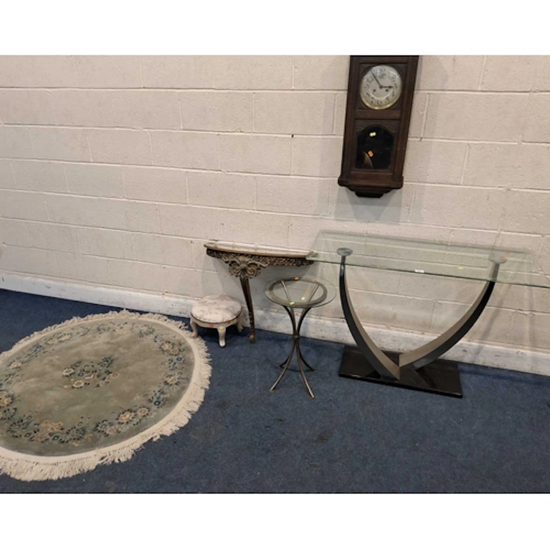 A GLASS SIDE TABLE, raised on metal legs, a circular glass t...