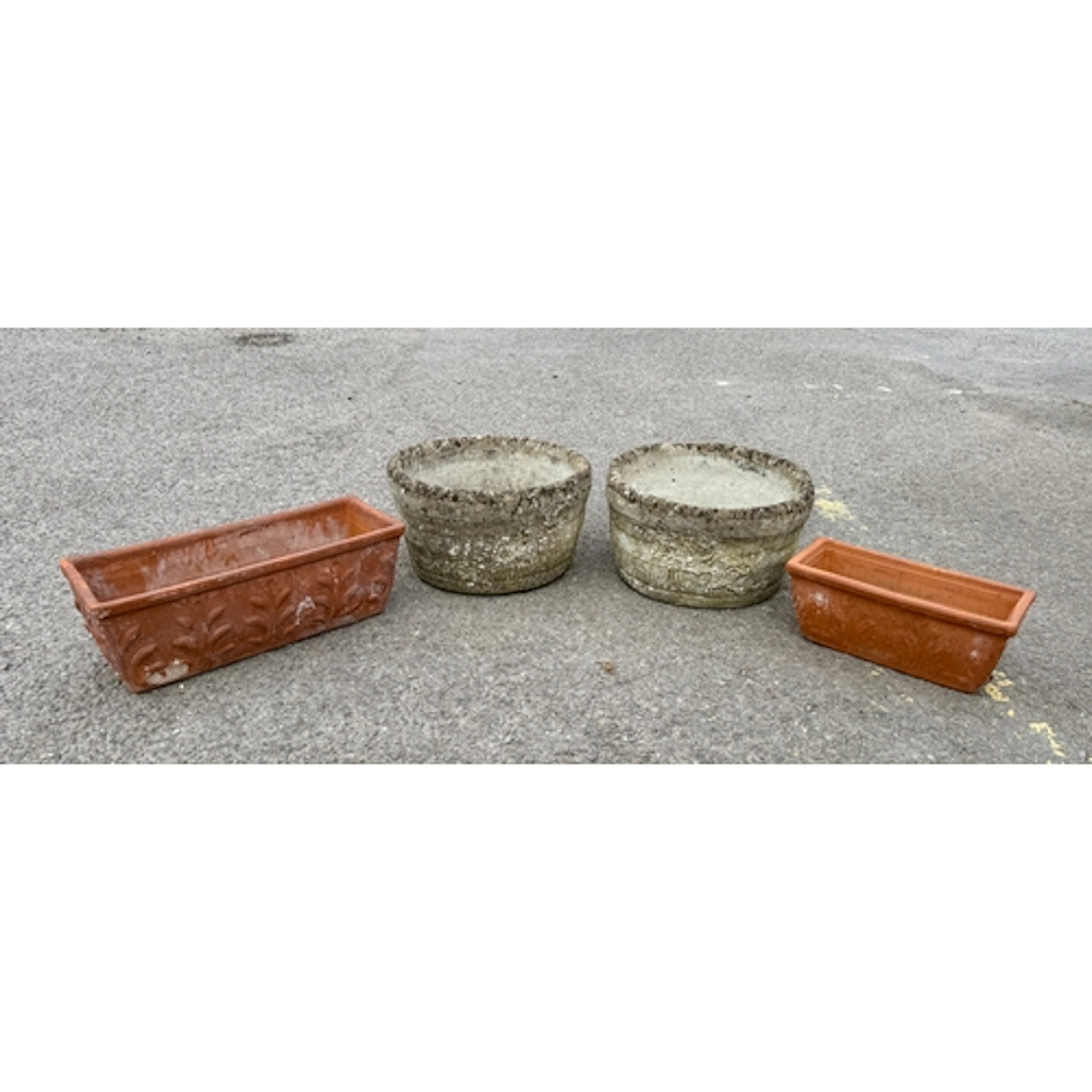 A pair of composite stone circular planters - with moulded c...