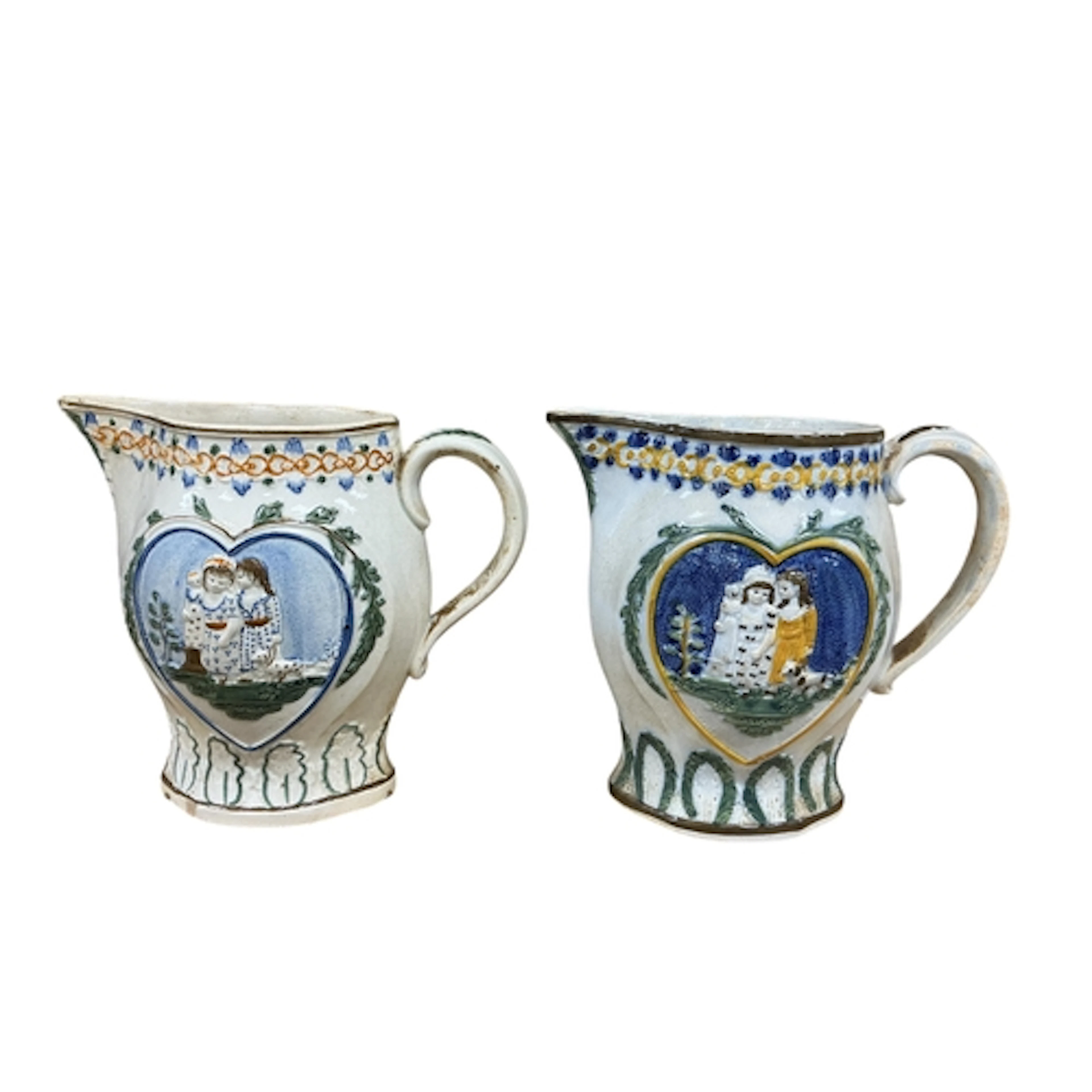 A pair of early 19th century Prattware jugs relief moulded w...
