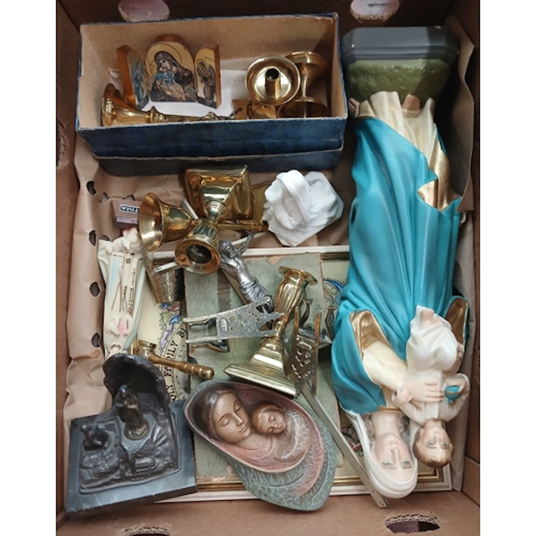 A box of religious figures and metalware.