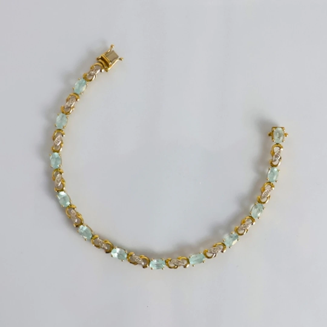 A contemporary 9ct gold bracelet, the blue stones (possibly ...