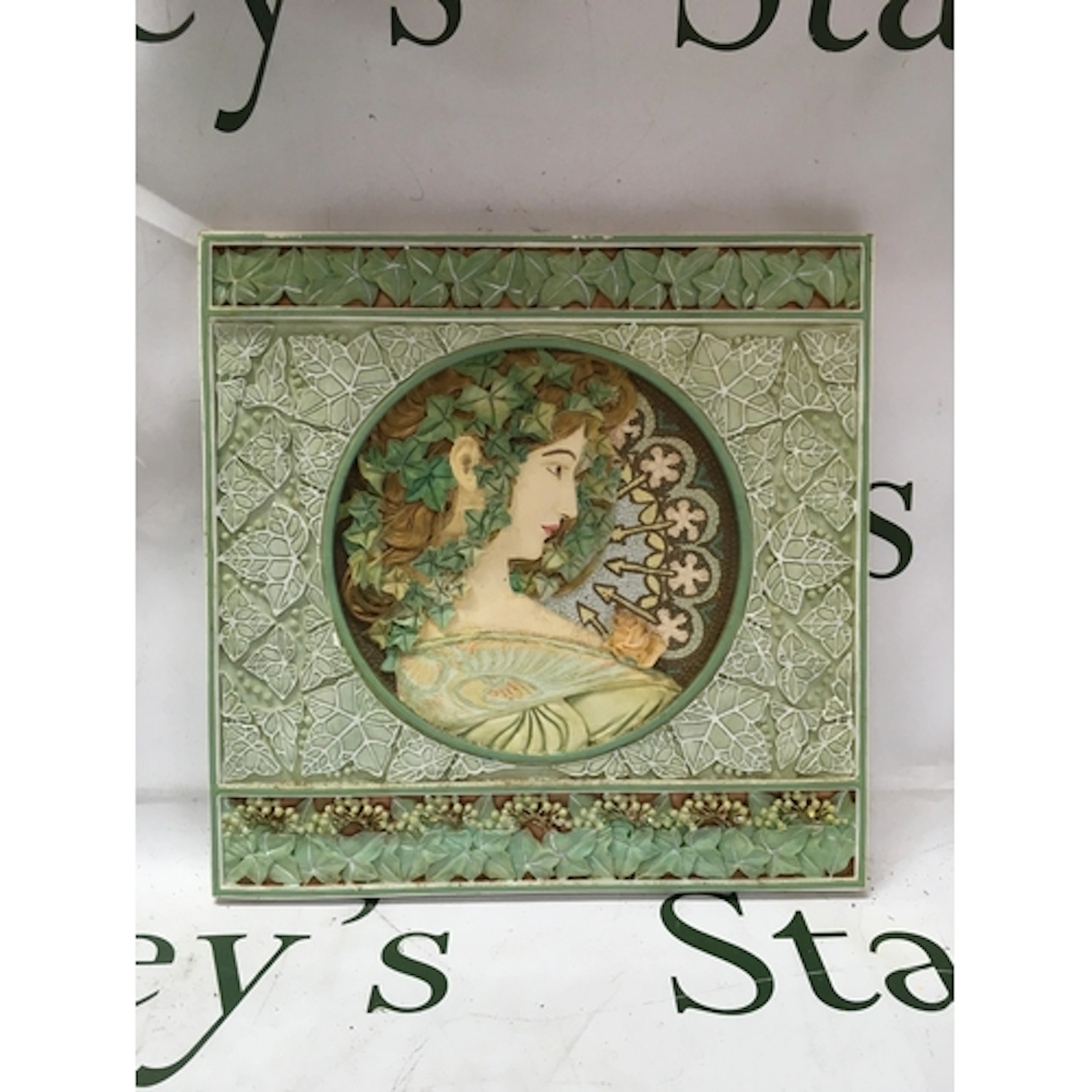 A decorative plaque featuring the Ivy design by Alphonse Muc...
