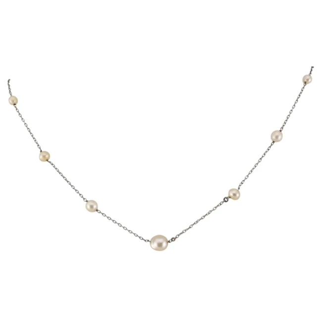 A white metal pearl necklace strung with seven graduating pe...