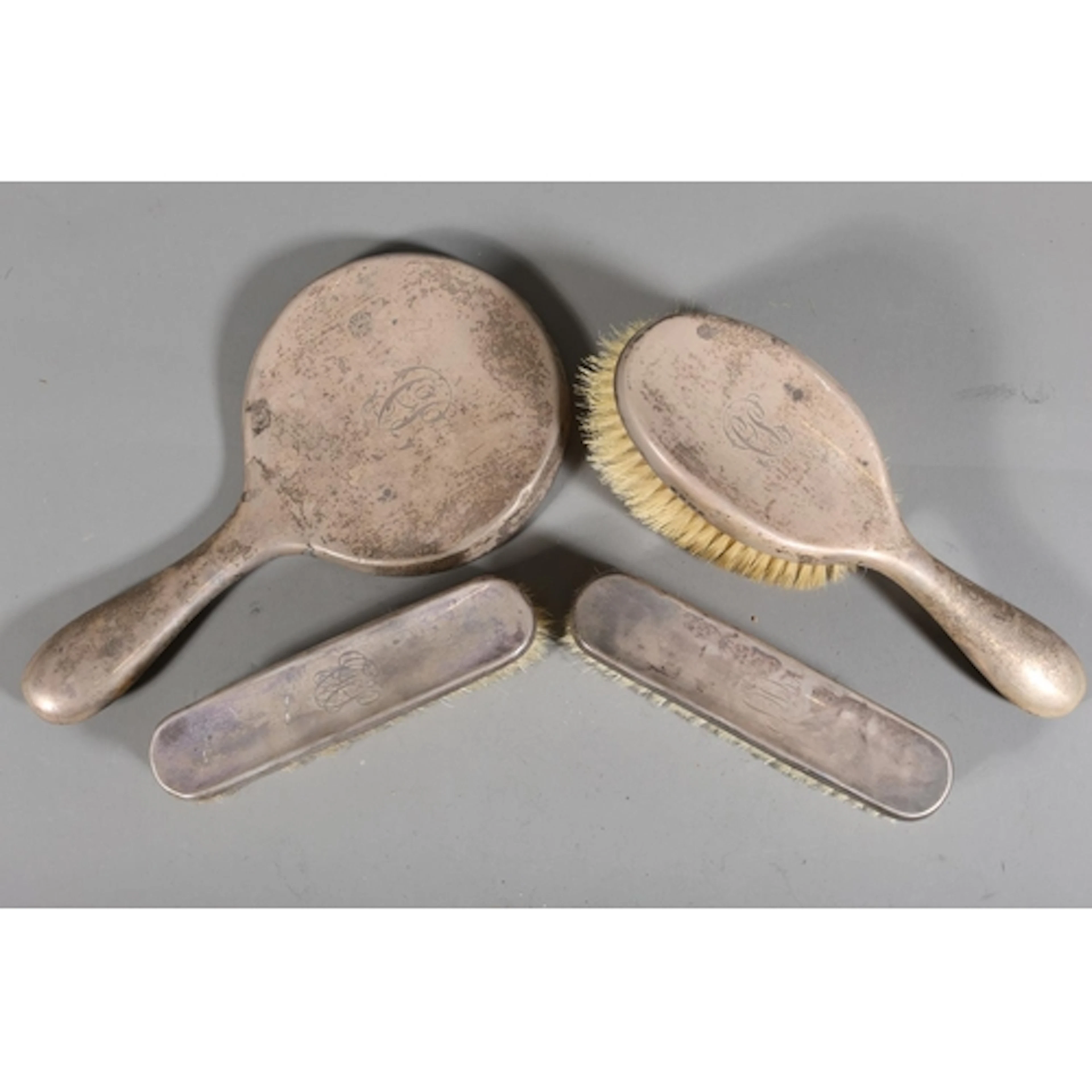 Harlequin silver four piece dressing table set.