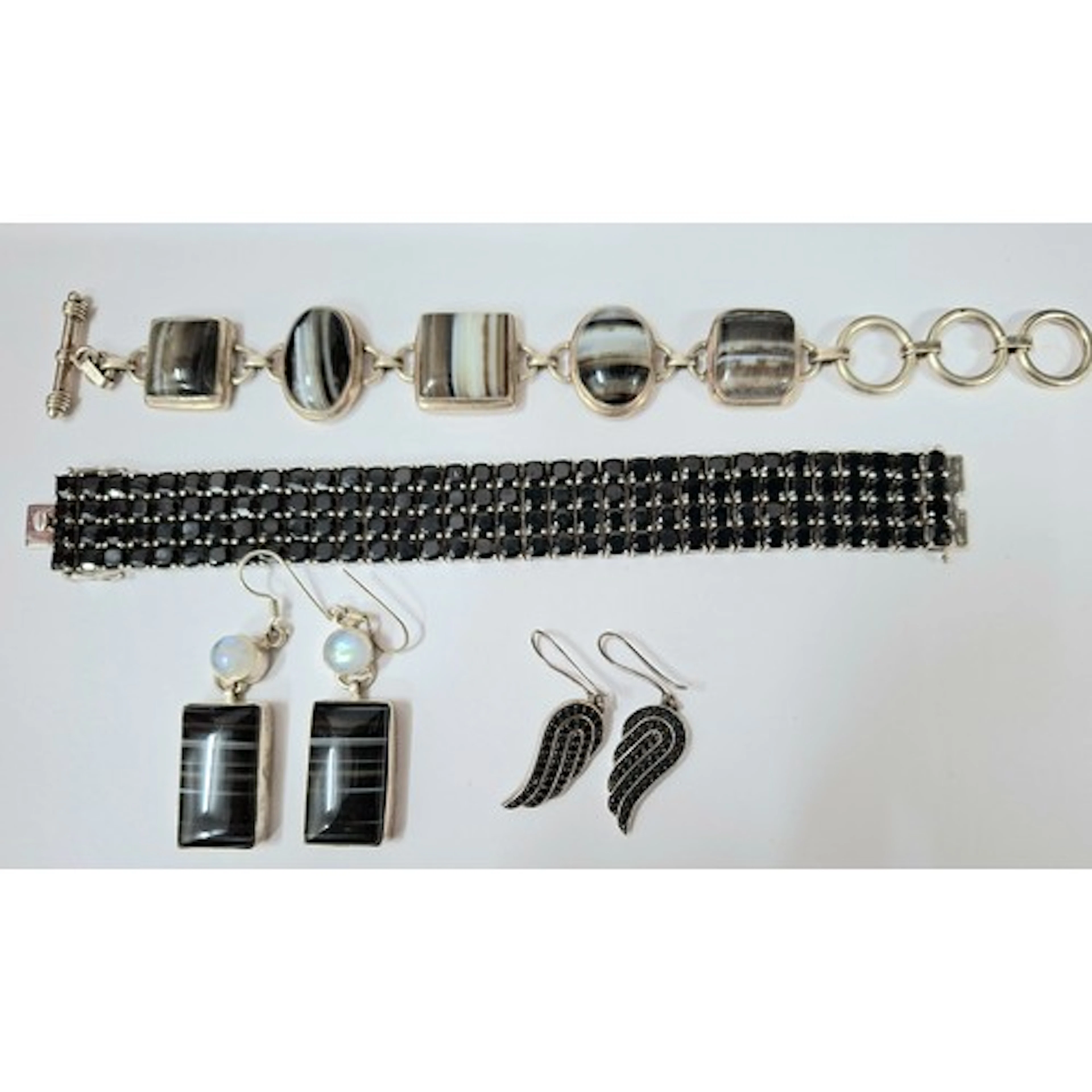 A silver and black spinel bracelet together with matched ear...