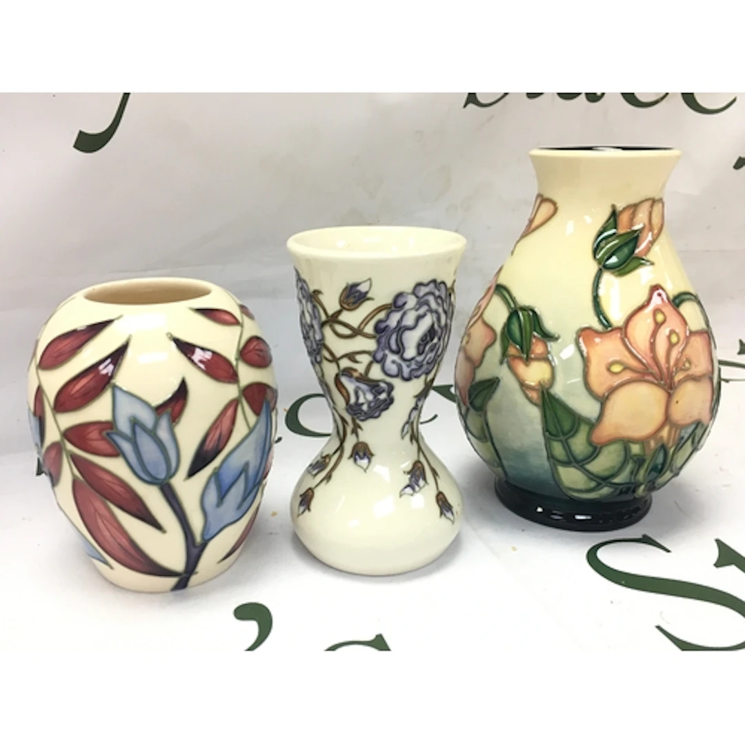 Three Moorcroft floral vases including a water cranesbill, B...