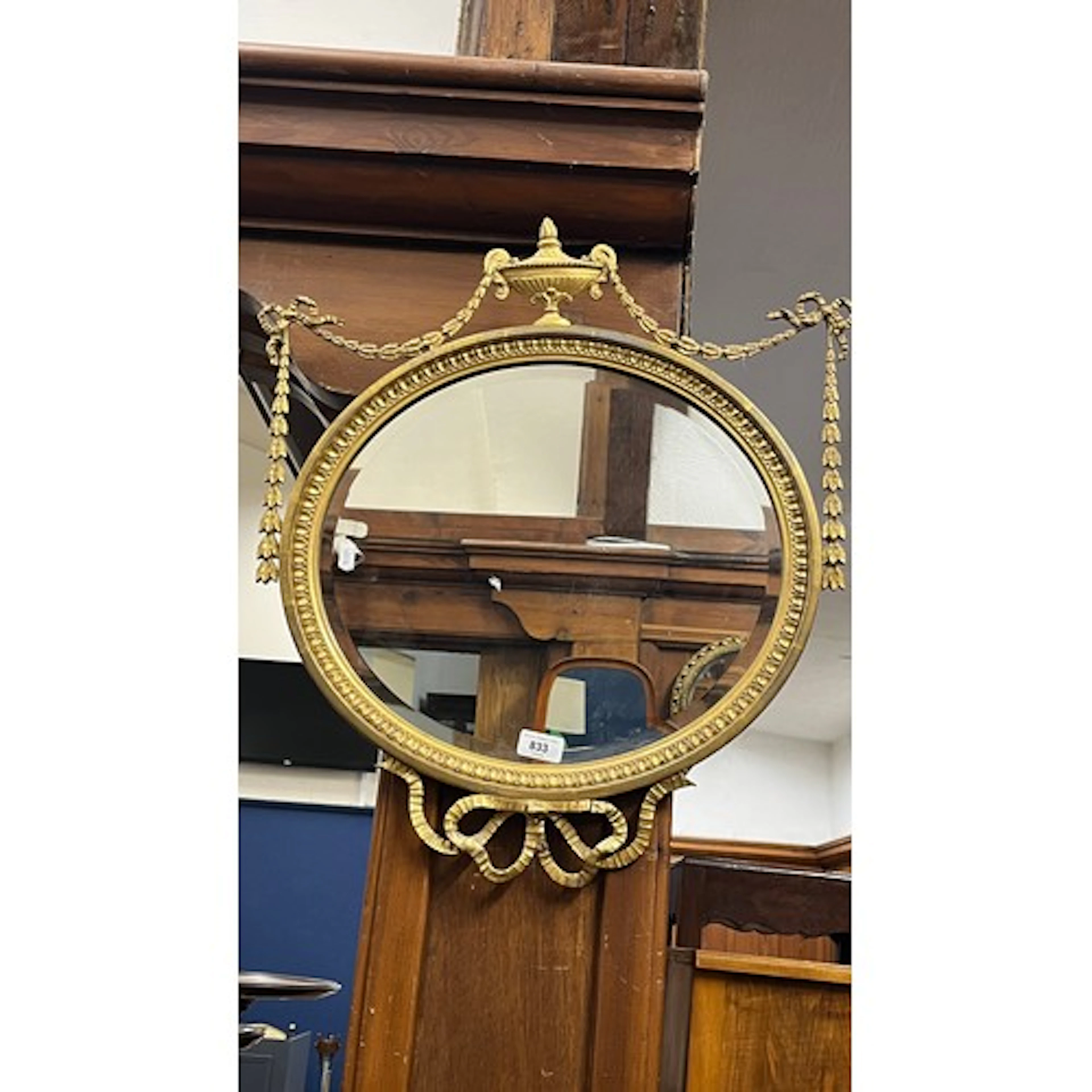 Adam revival gilt framed oval mirror with urn surmount and s...