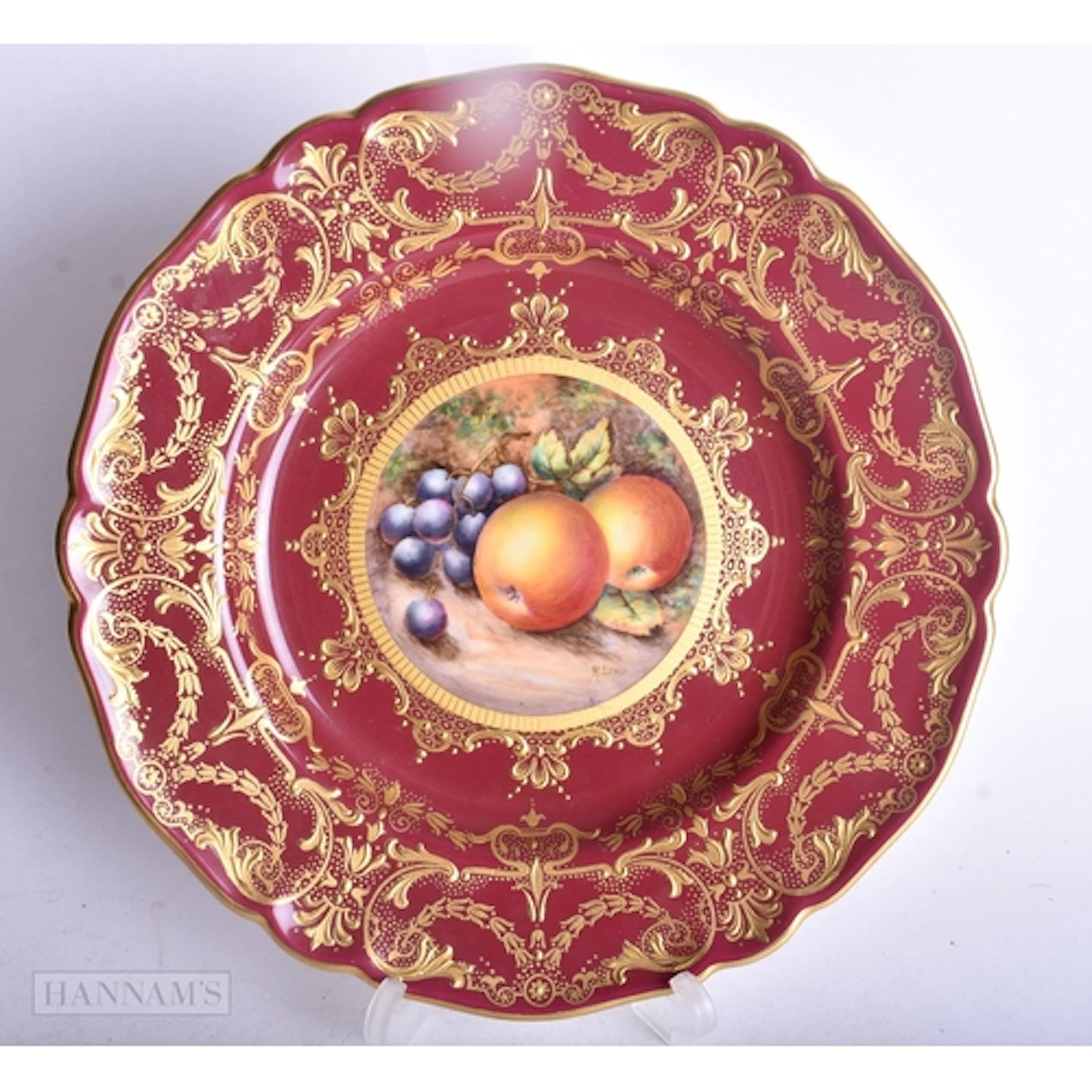 Royal Worcester claret ground plate painted with fruit on a ...