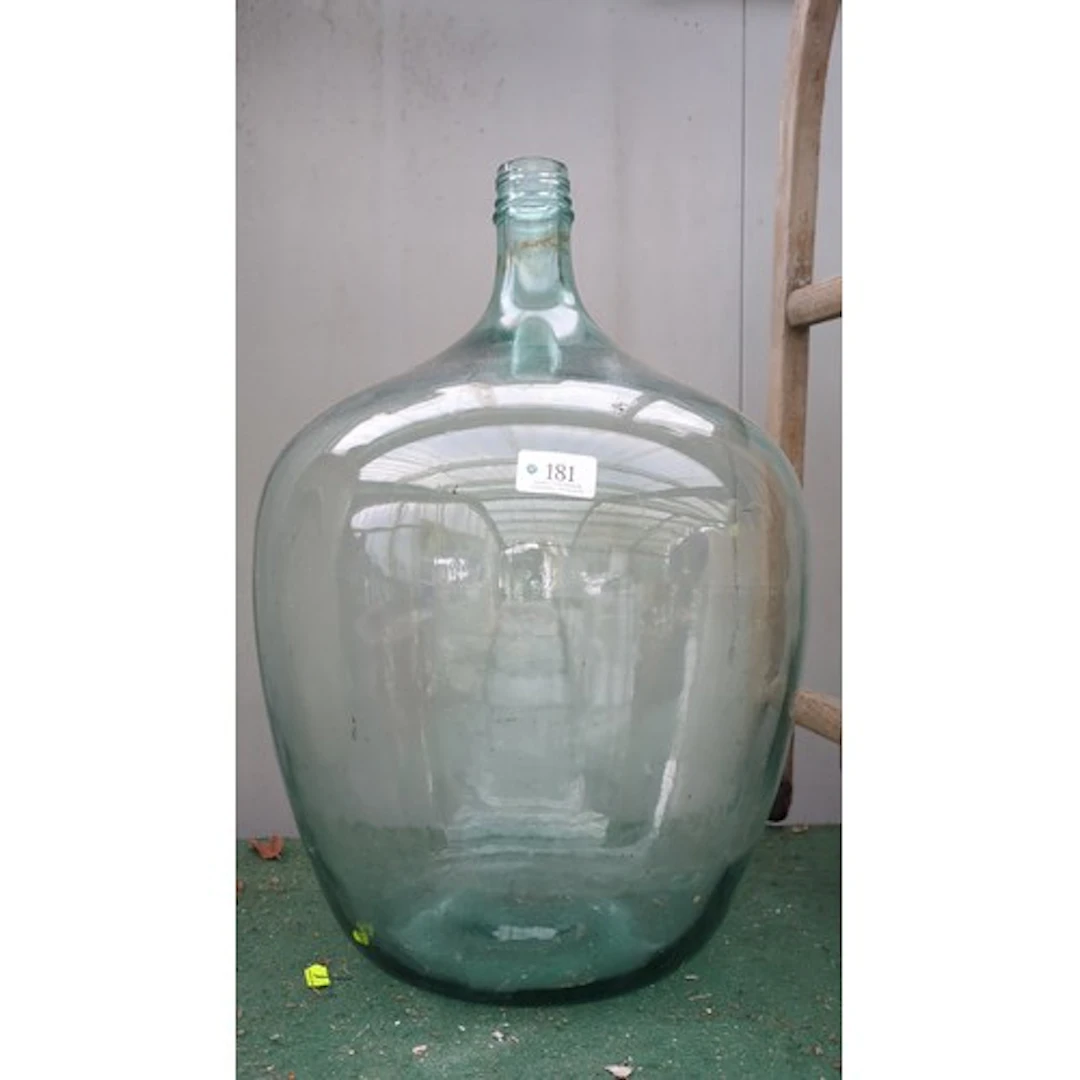 Large pale aqua glass demijohn with a narrow neck and moulde...