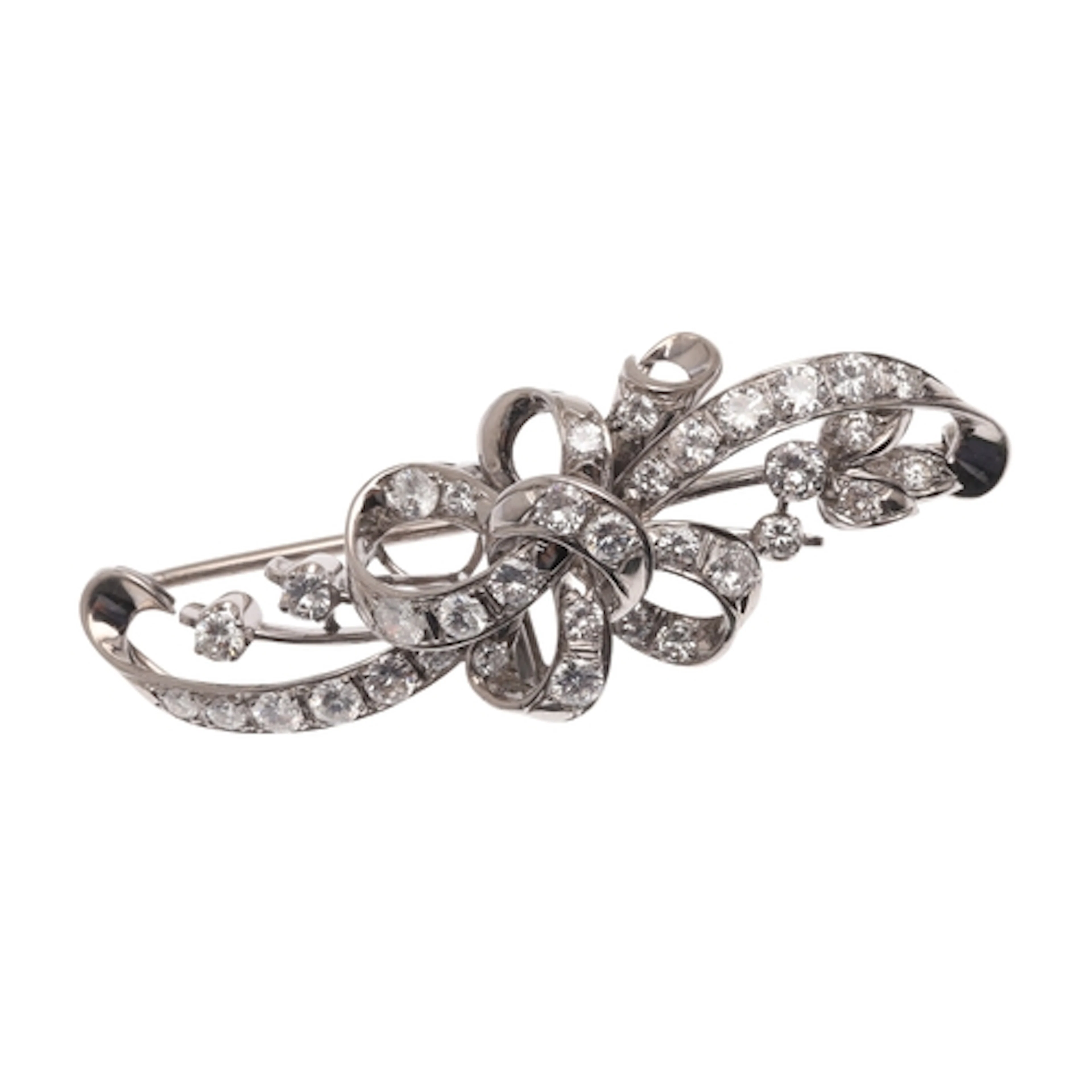 A DIAMOND BROOCH. of foliate and ribbon design, set througho...
