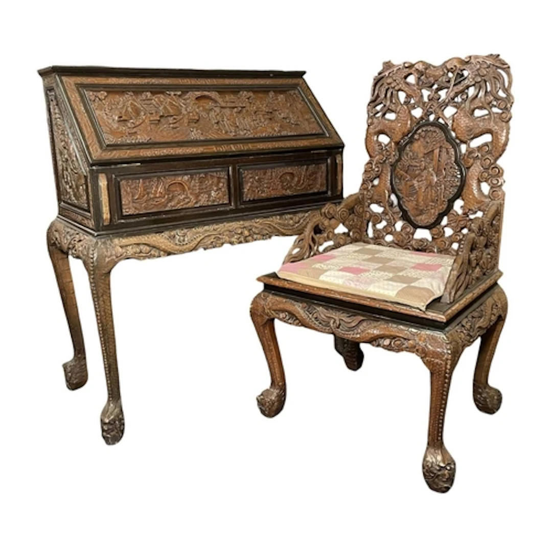 A 20th century Chinese hardwood carved bureau desk and chair...