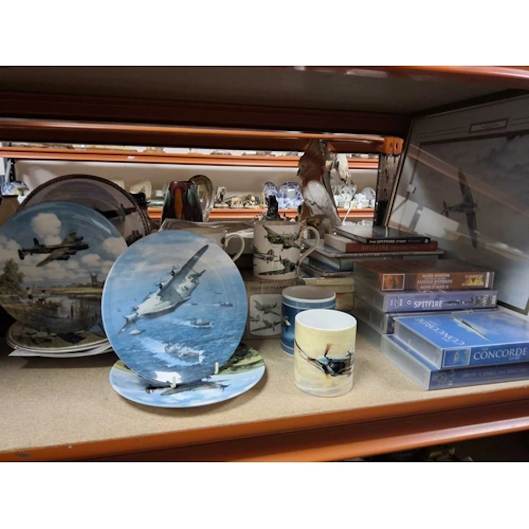 A COLLECTION OF RAF THEMED ORNAMENTS, MUGS, BOOKS, AND VHS c...