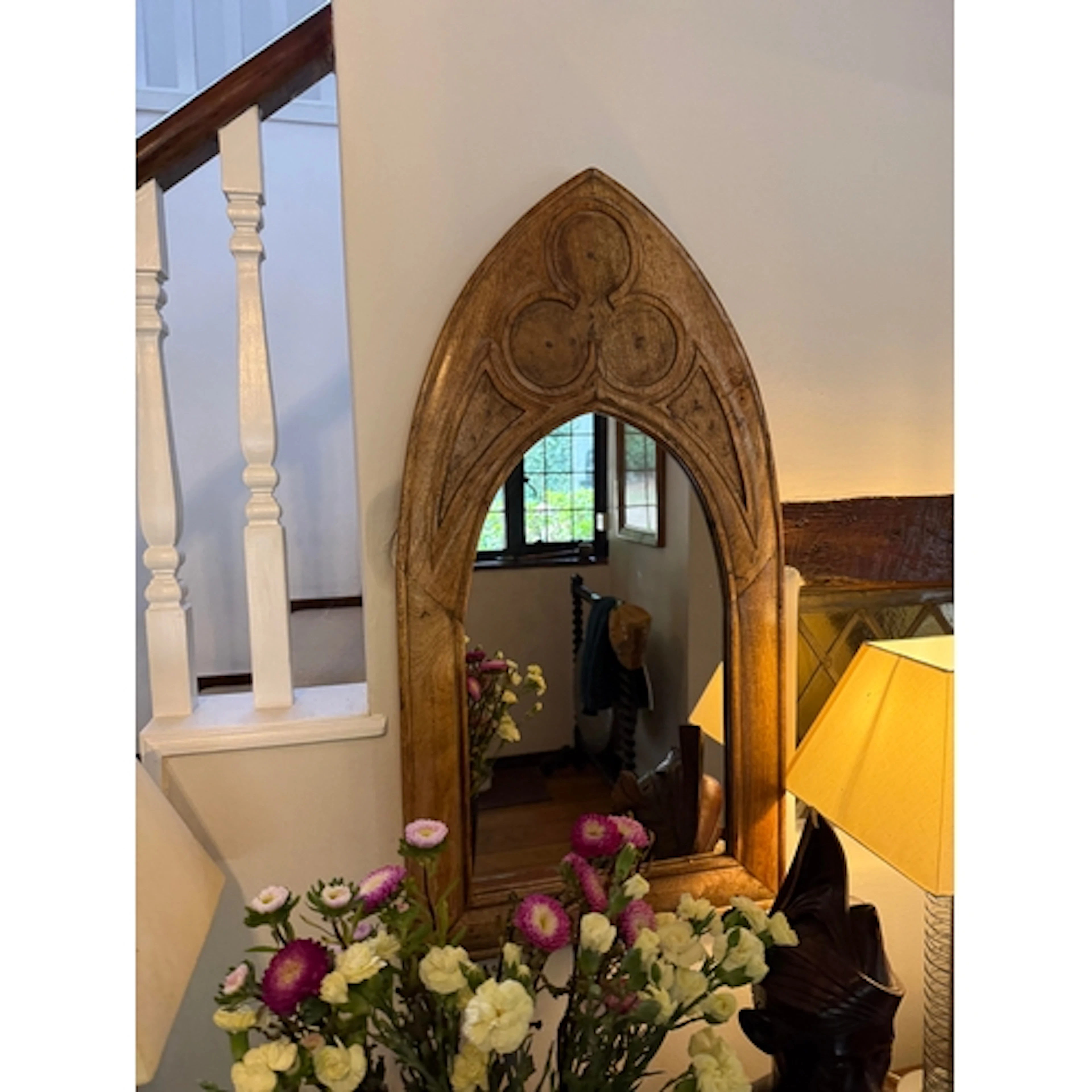 AN ARCHED GOTHIC STYLE WALL MIRROR