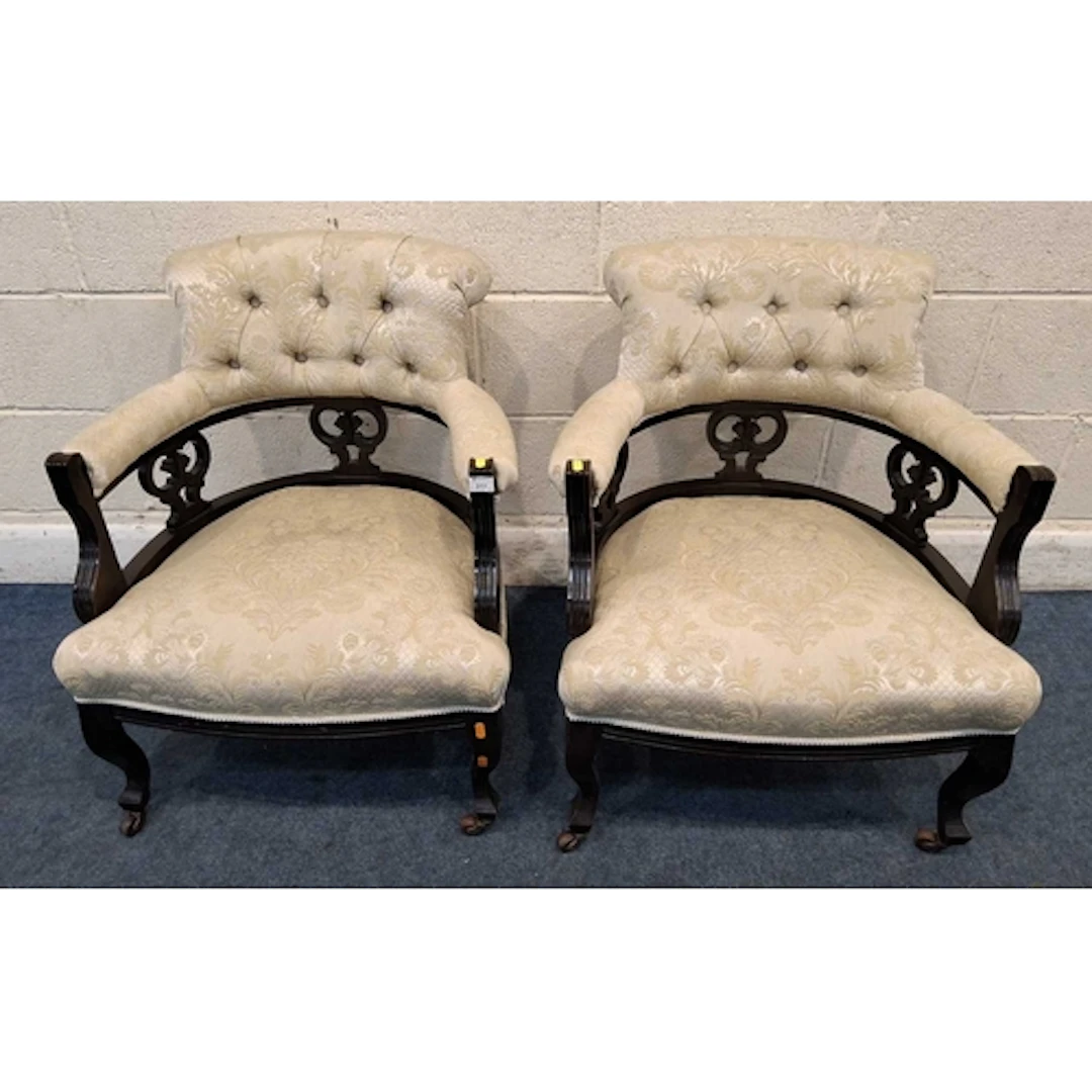 A PAIR OF EARLY 20TH CENTURY BOW TOP ARMCHAIRS, with beige a...