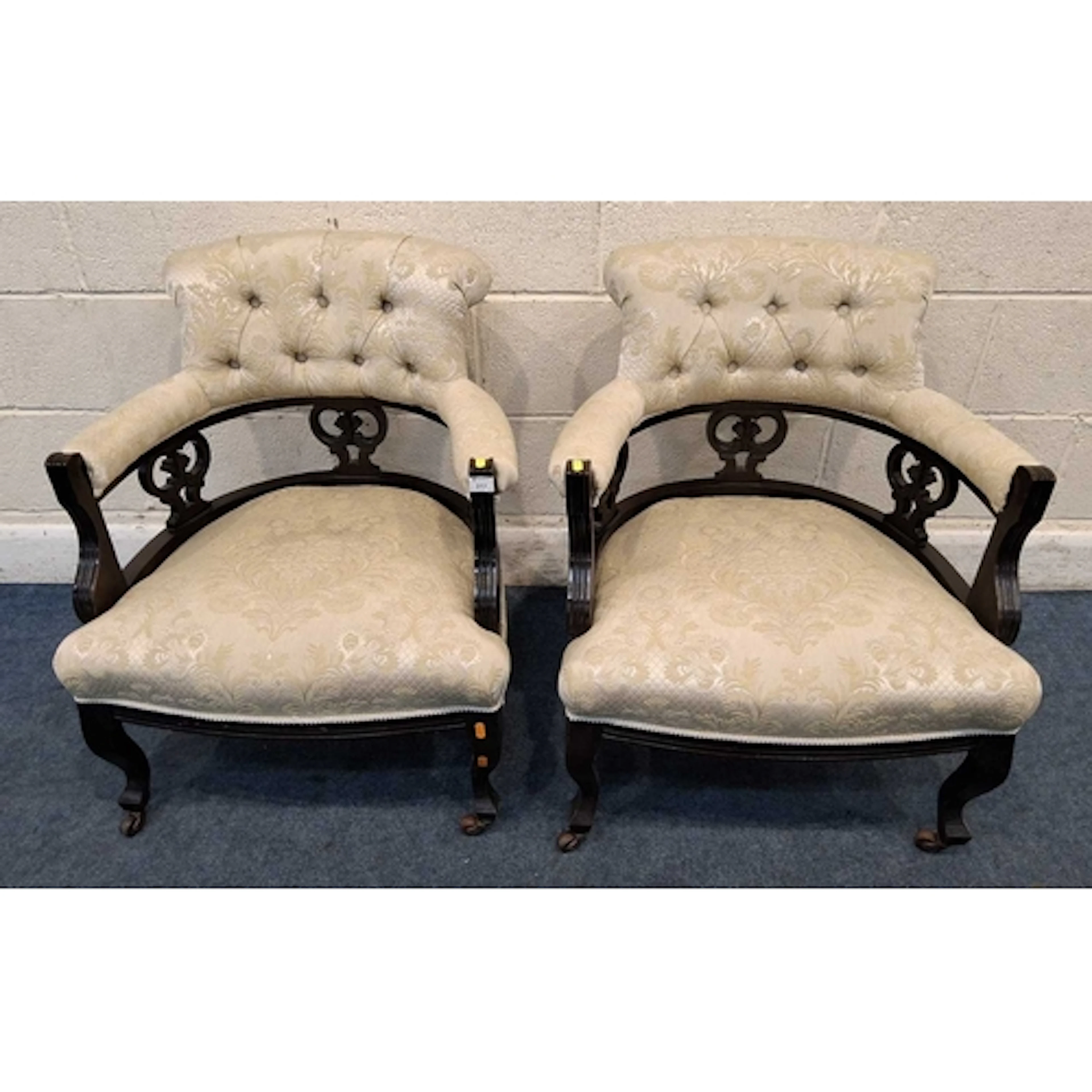 A PAIR OF EARLY 20TH CENTURY BOW TOP ARMCHAIRS, with beige a...