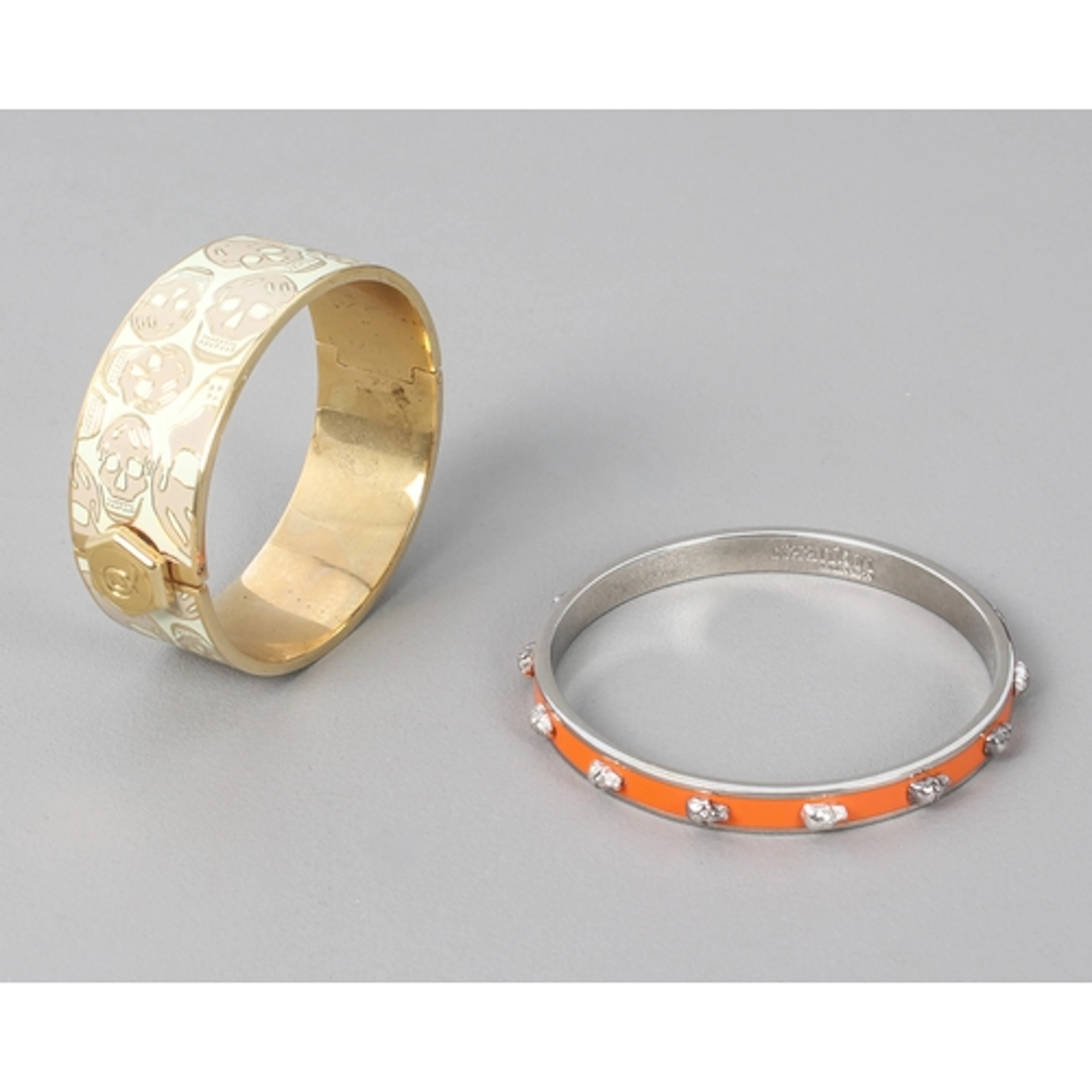 Two skull bangles by Alexander McQueen - one hinged, with en...