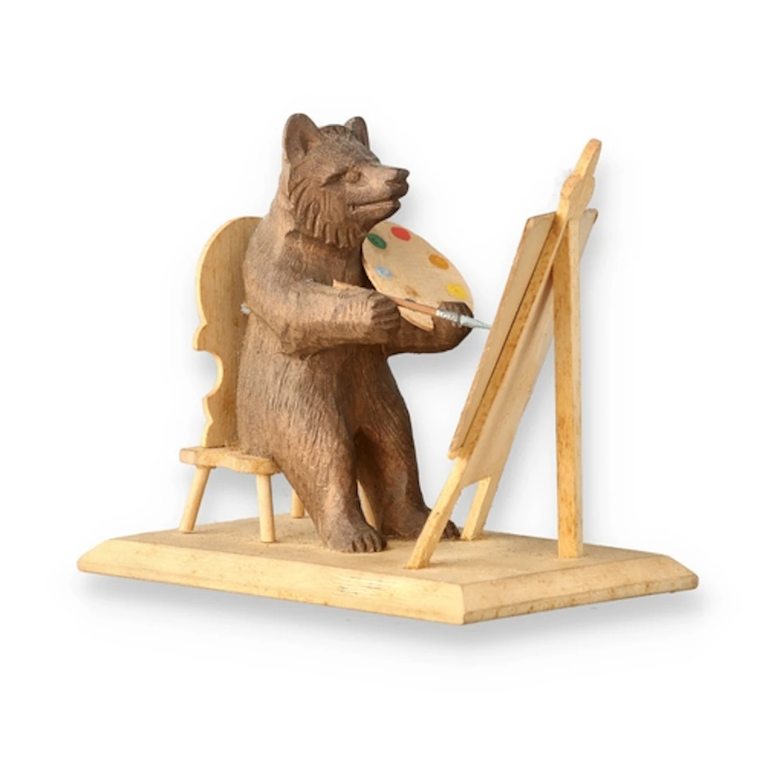 A BLACK FOREST CARVED WOOD BEAR The bear painting a mountain...