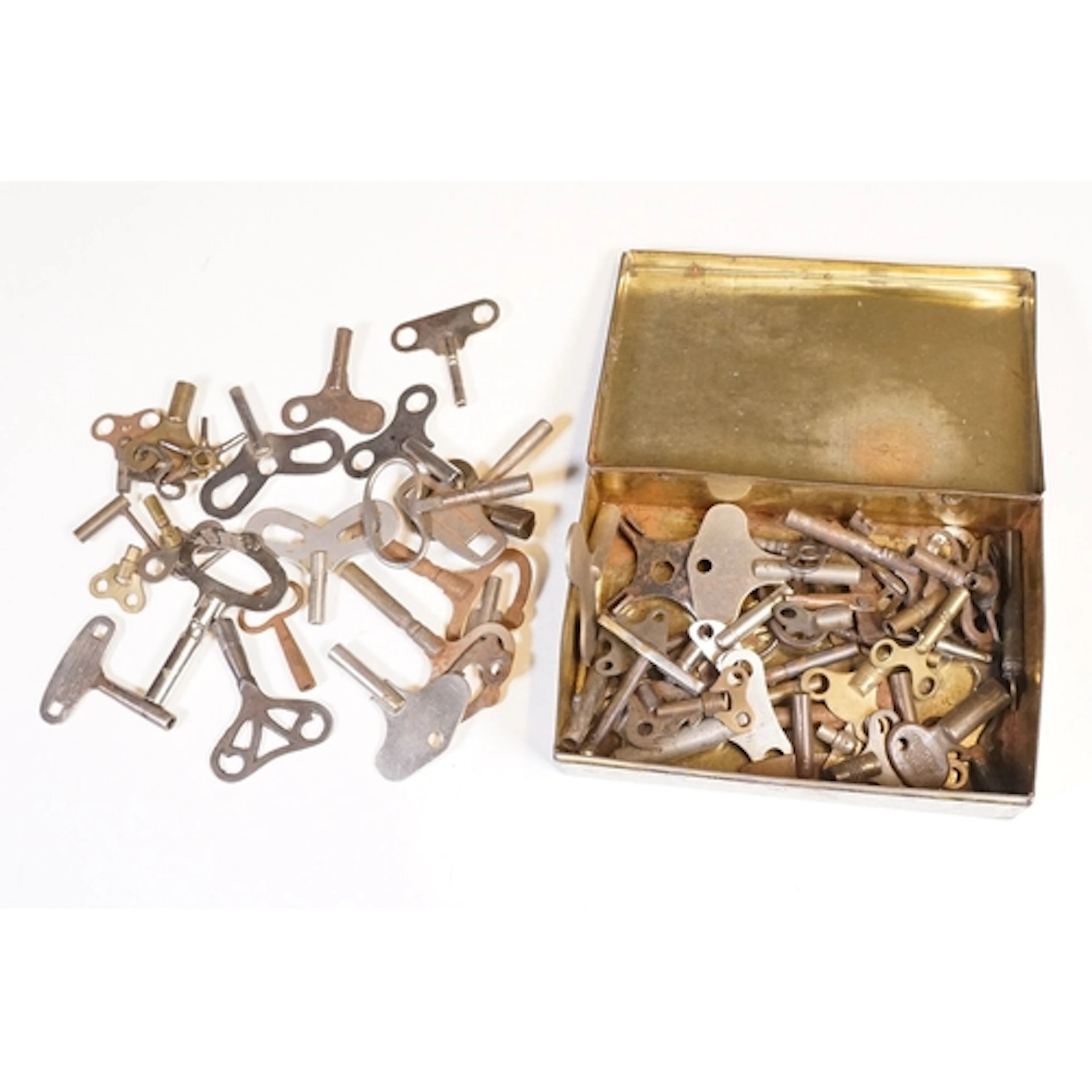 A collection of vintage and contemporary clock keys within a...