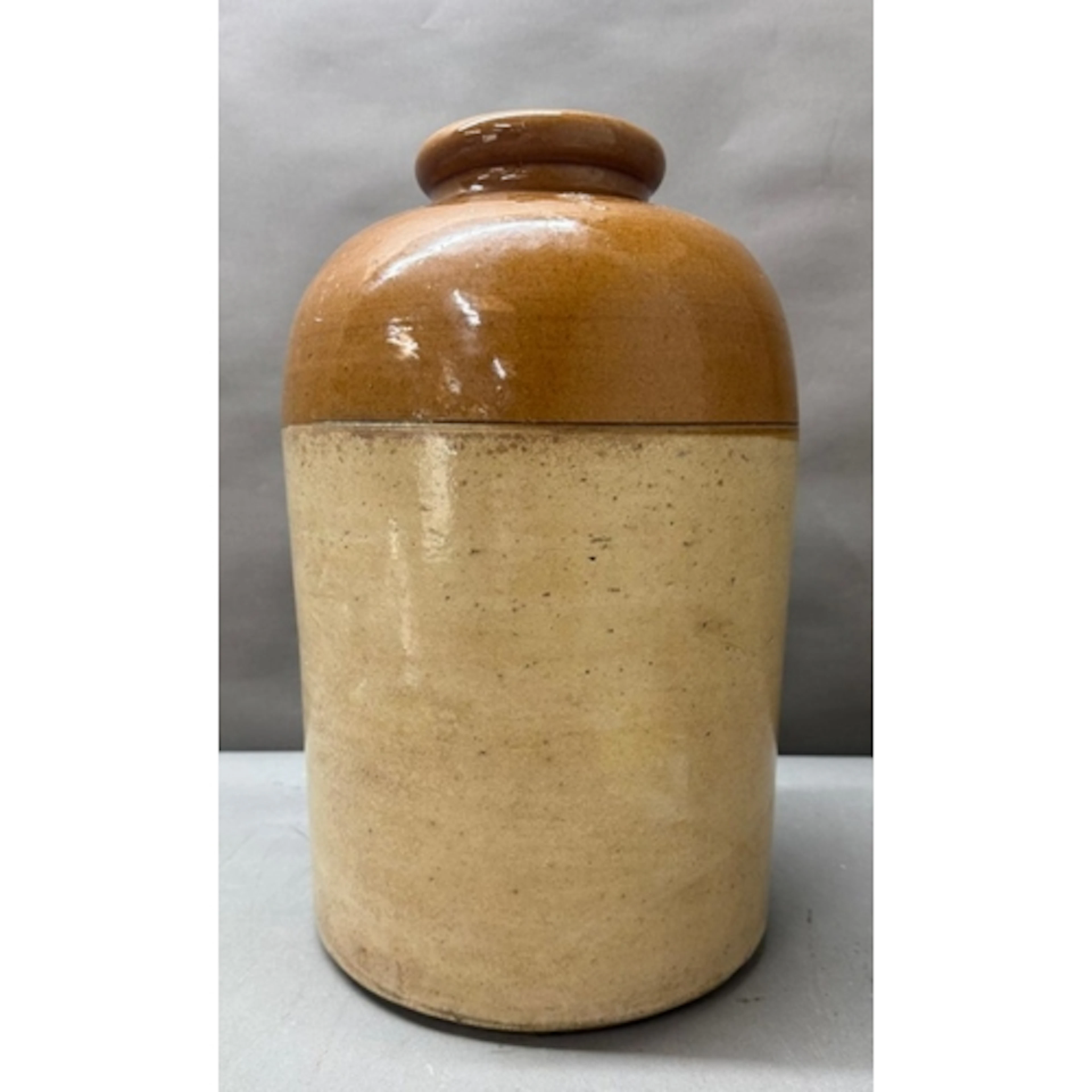 A four gallon two tone glazed stoneware storage jar. Height ...
