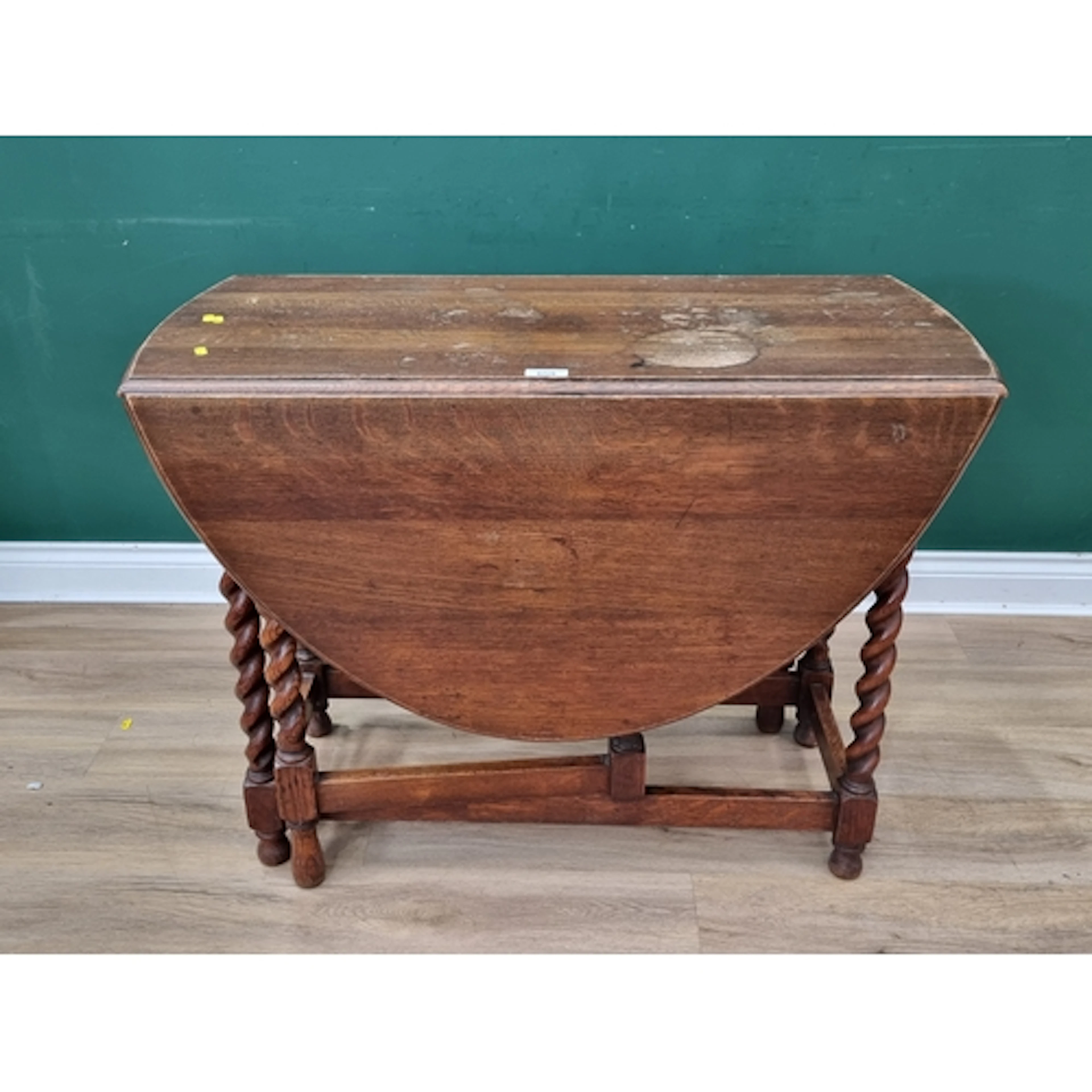 An oak Gateleg Dining Table raised on barley twist supports,...