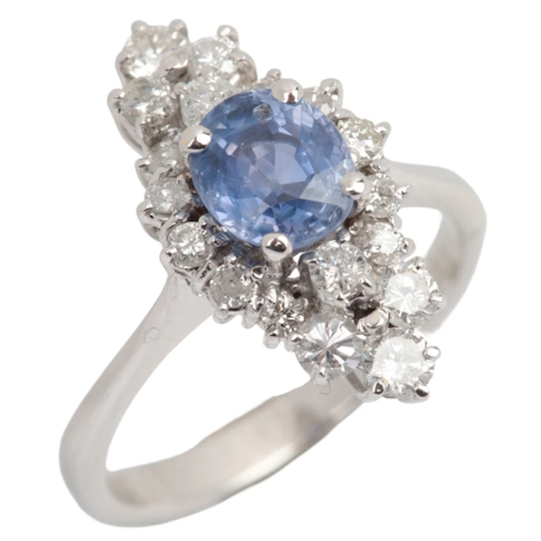 A colour-change sapphire and diamond ring, claw-set with an ...