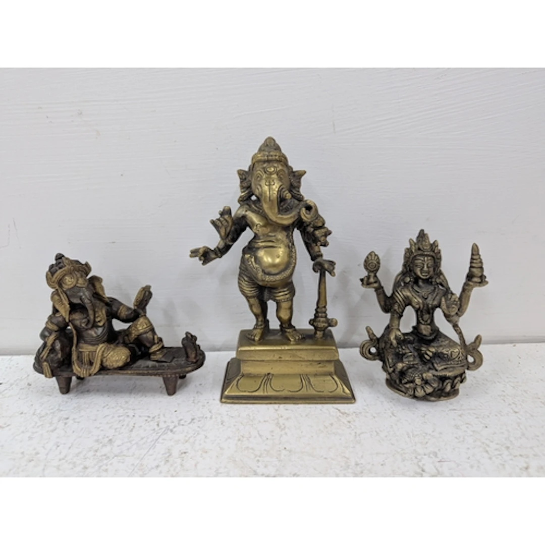 Three figures of Asian deities to include a seated Hindu dei...
