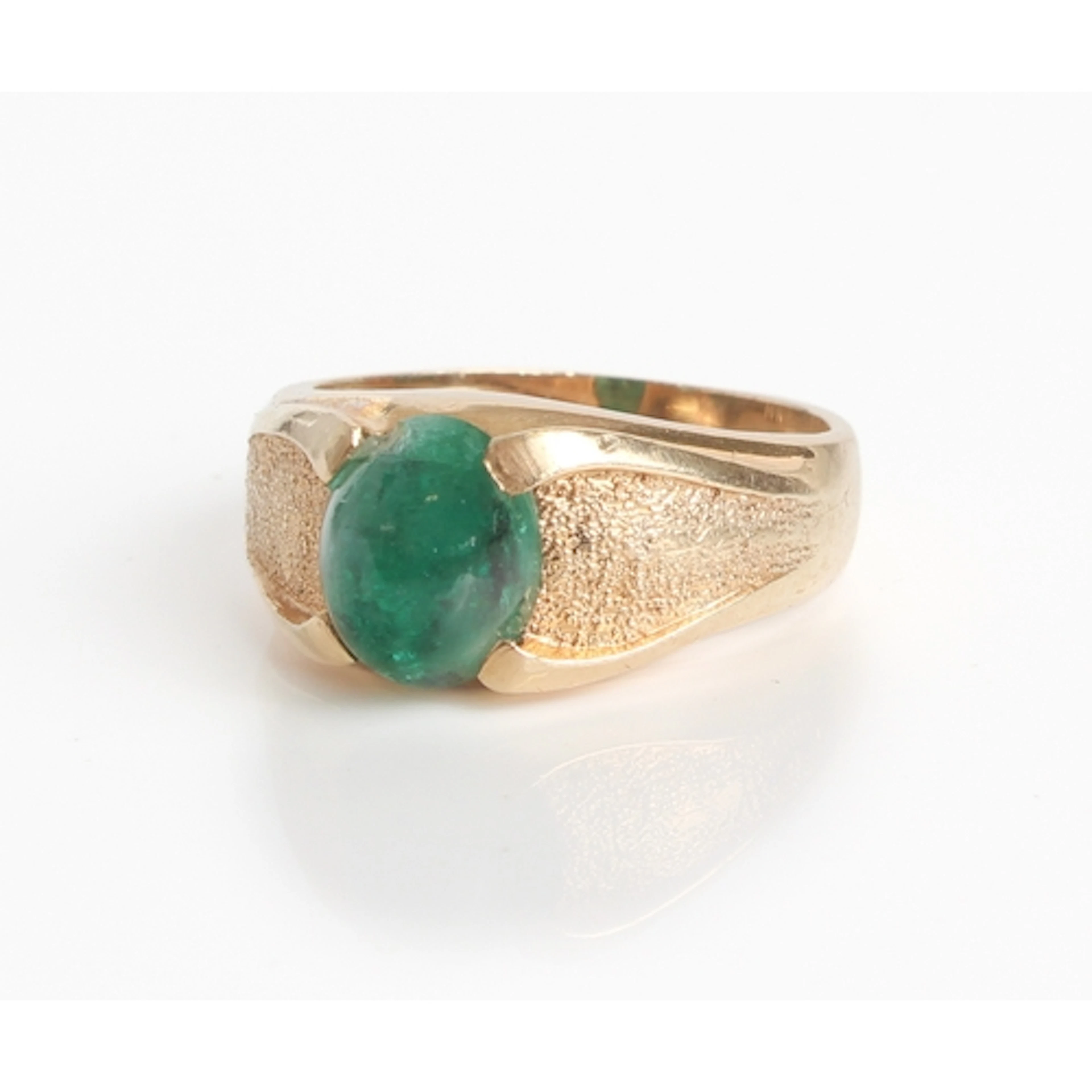 A 14ct gold ring set with a green cabochon stone.