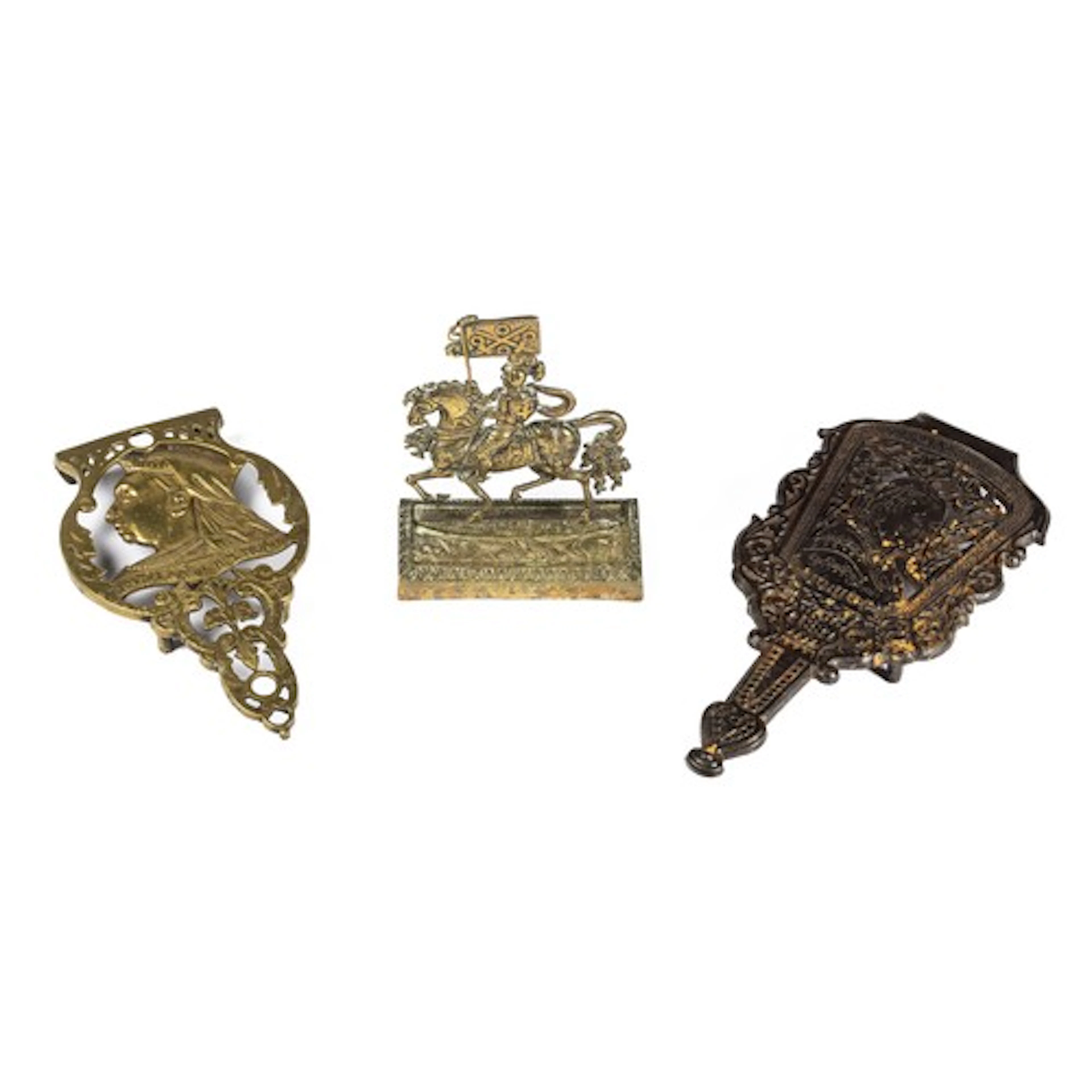 A Victorian cast iron trivit, decorated with a profile of Qu...