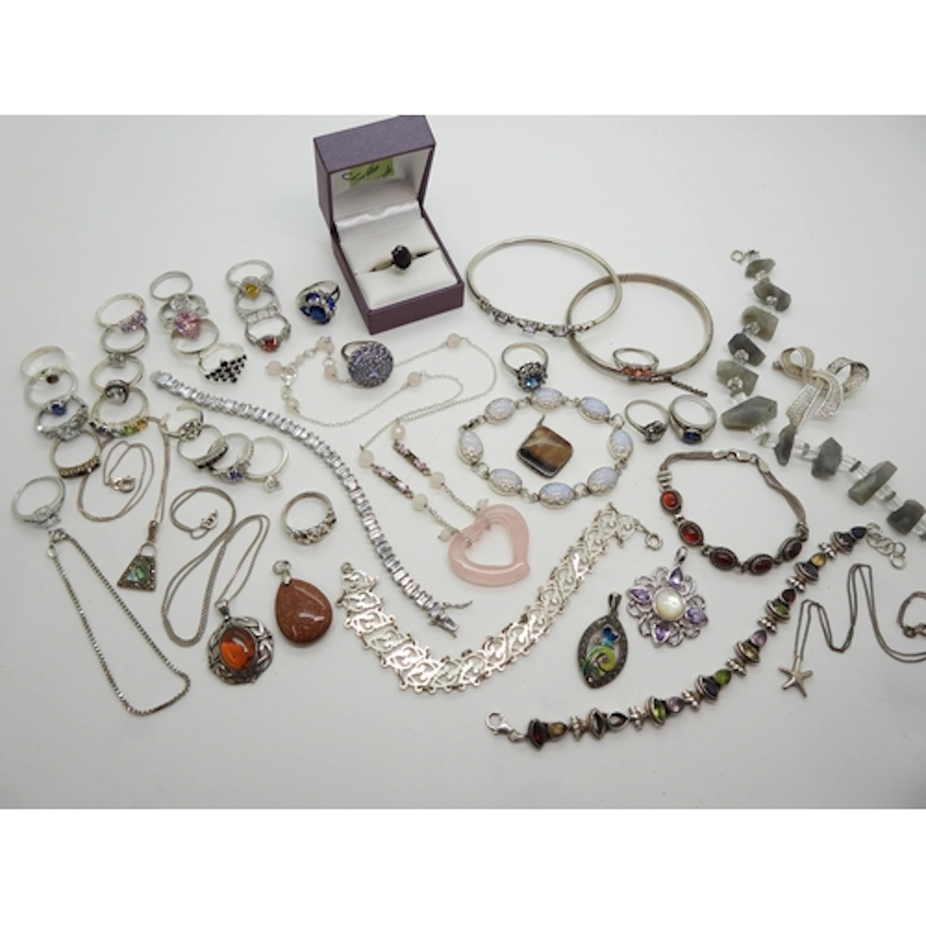 A collection of silver and white metal jewellery to include,...