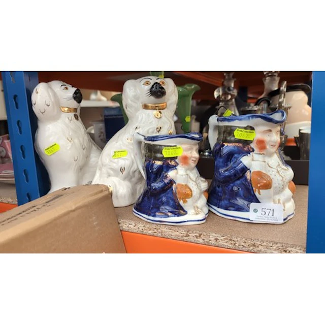 A pair of seated Staffordshire pottery spaniels with gilt co...