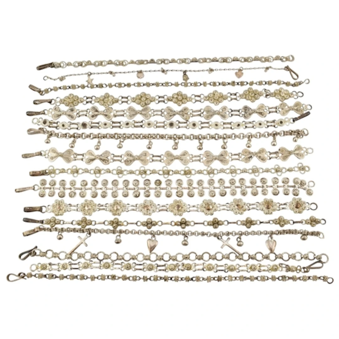 Collection of silver and white metal filigree bracelets. To ...