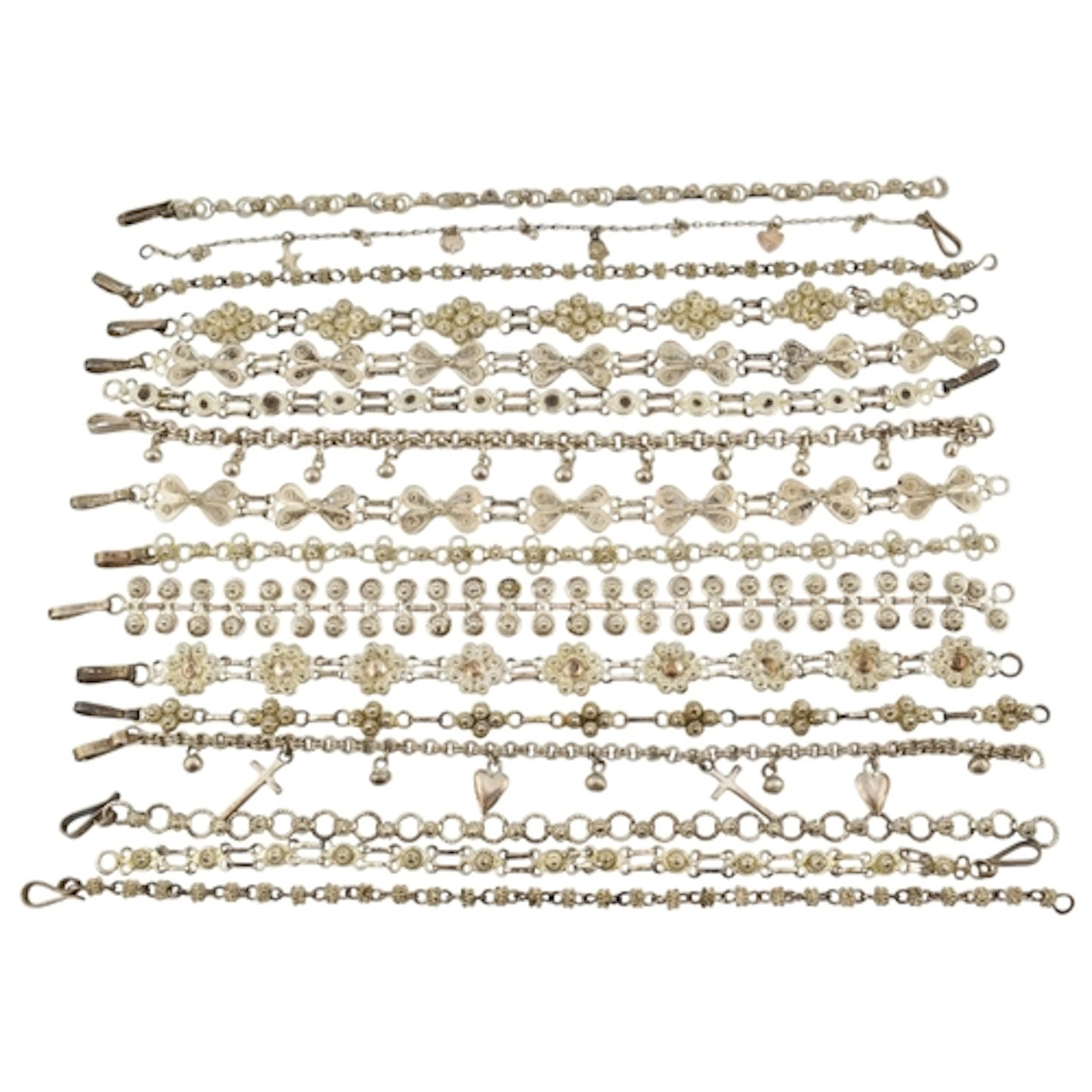Collection of silver and white metal filigree bracelets. To ...