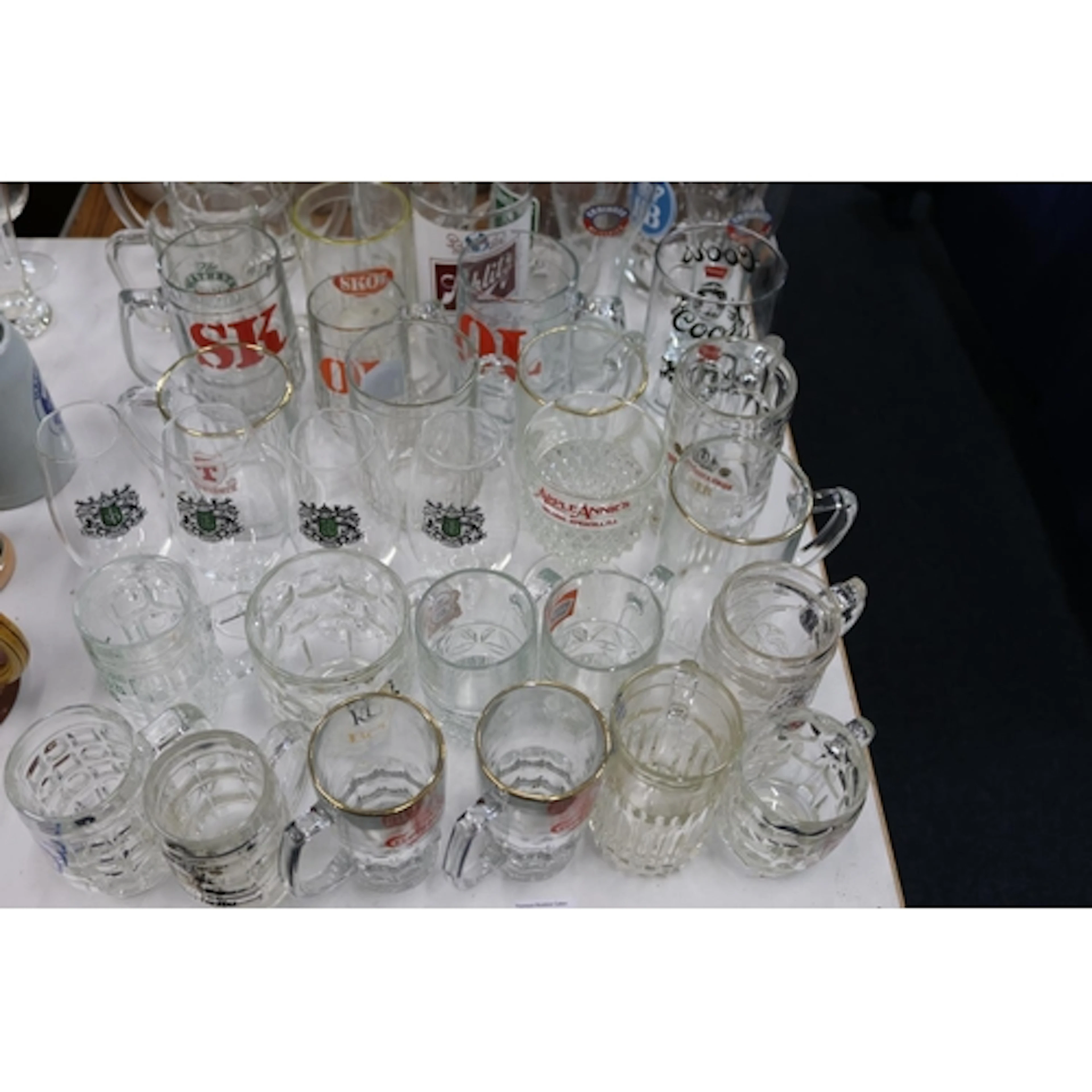 Branded glass beer mugs and tankards.