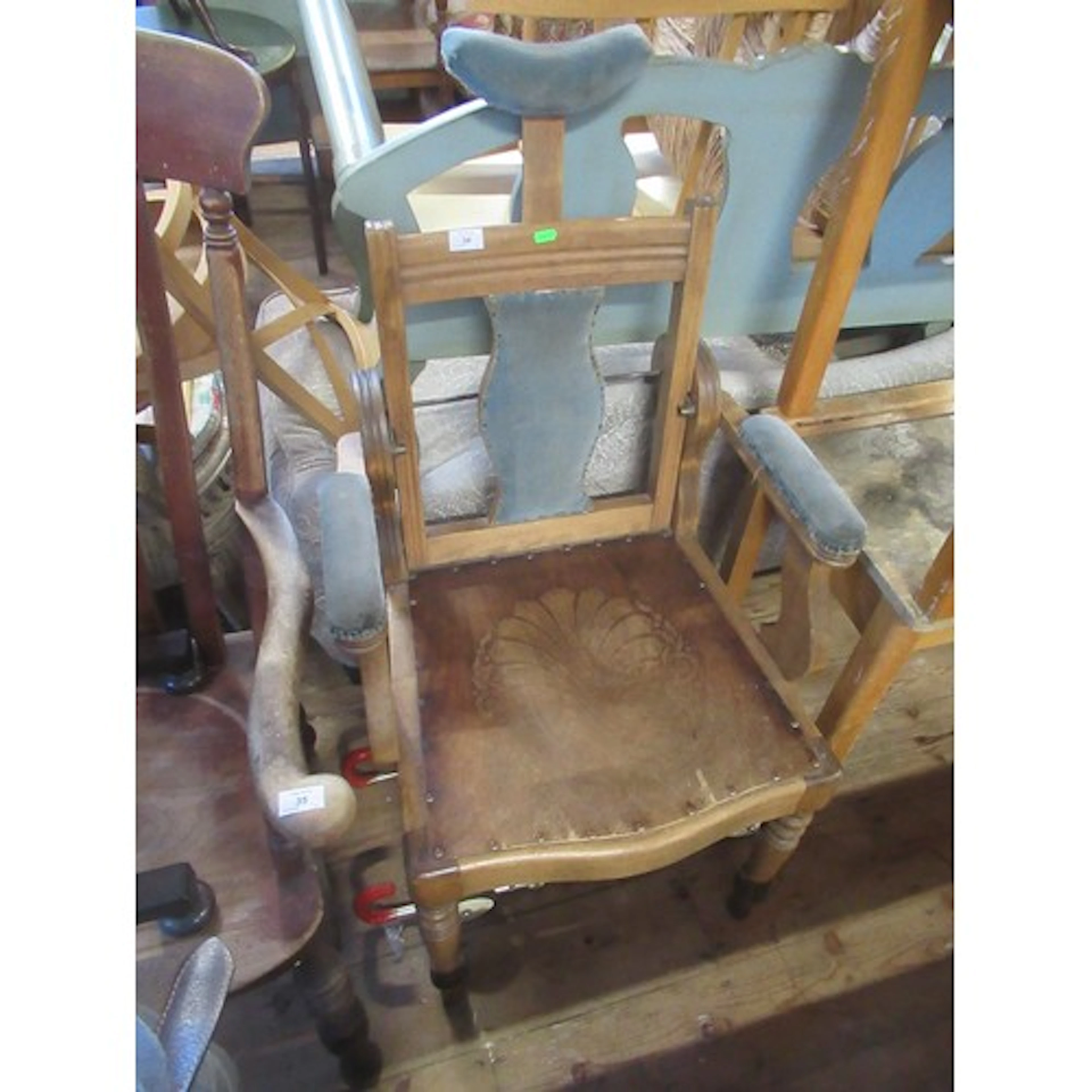 A vintage barbers chair together with a vintage stroller