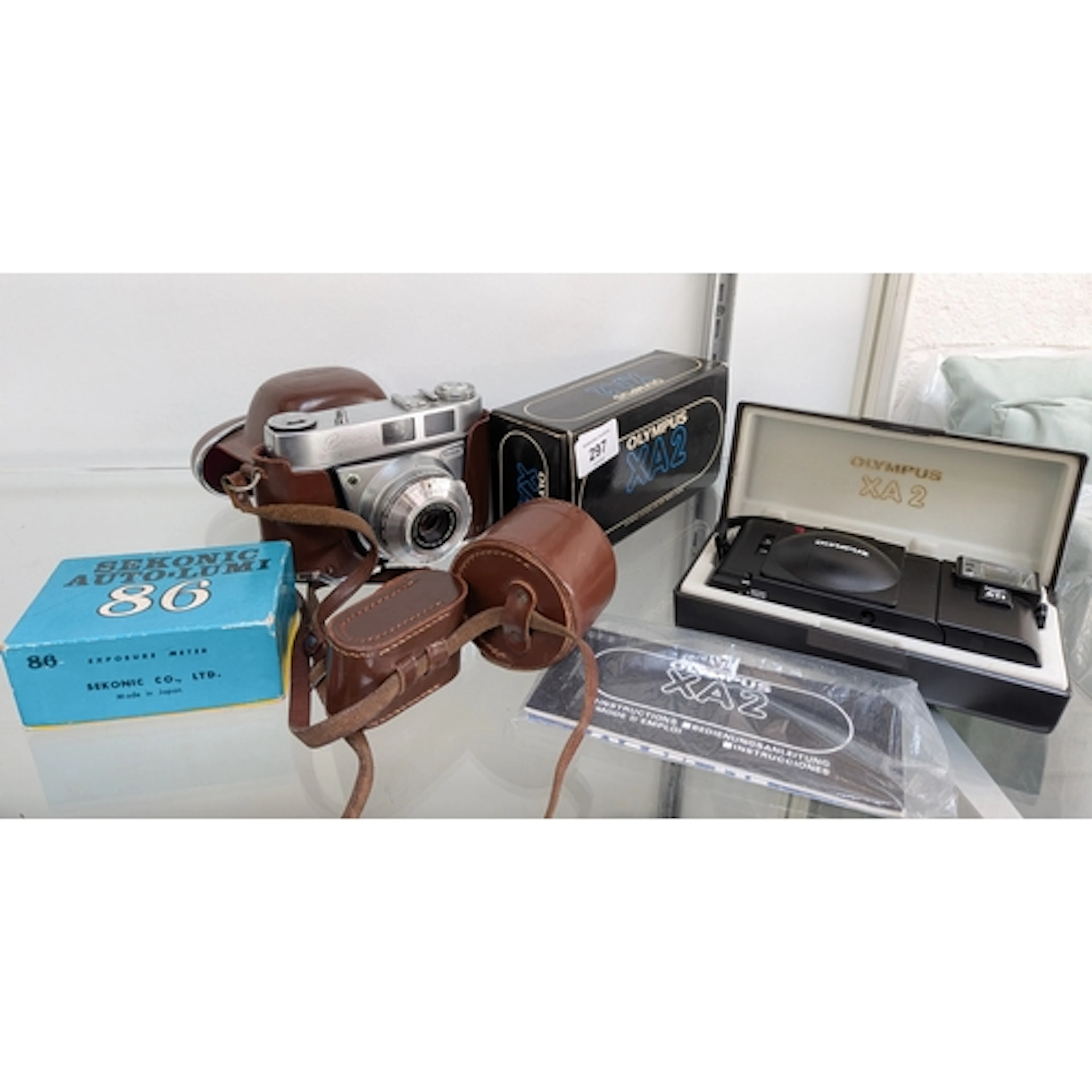 An Olympus XA2 camera in case together with a Sekonic auto-l...