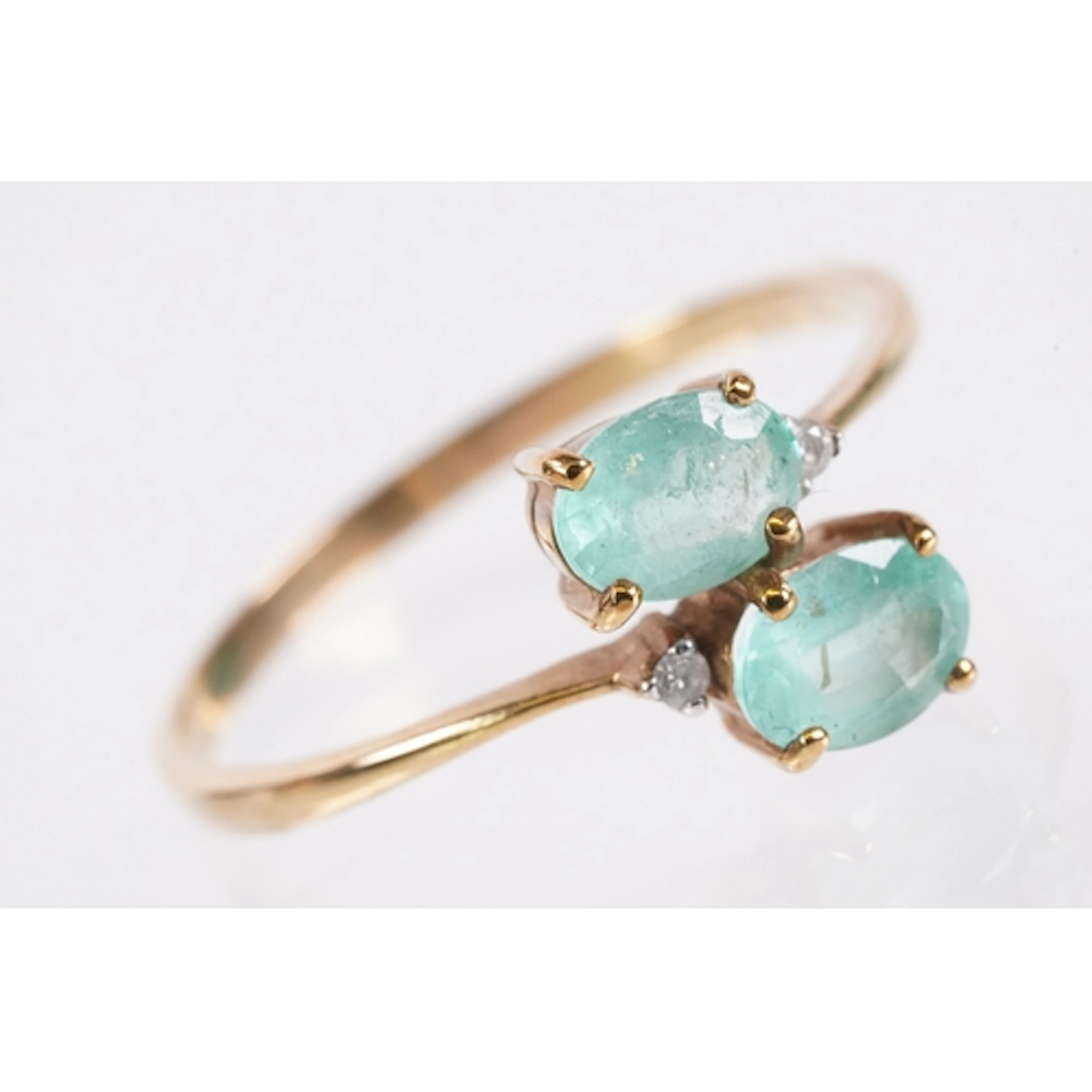 9ct gold emerald and diamond ring. The ring being set with t...