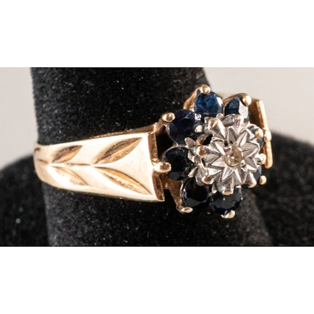 Jewellery: a 9ct yellow gold ring cluster set with sapphires...