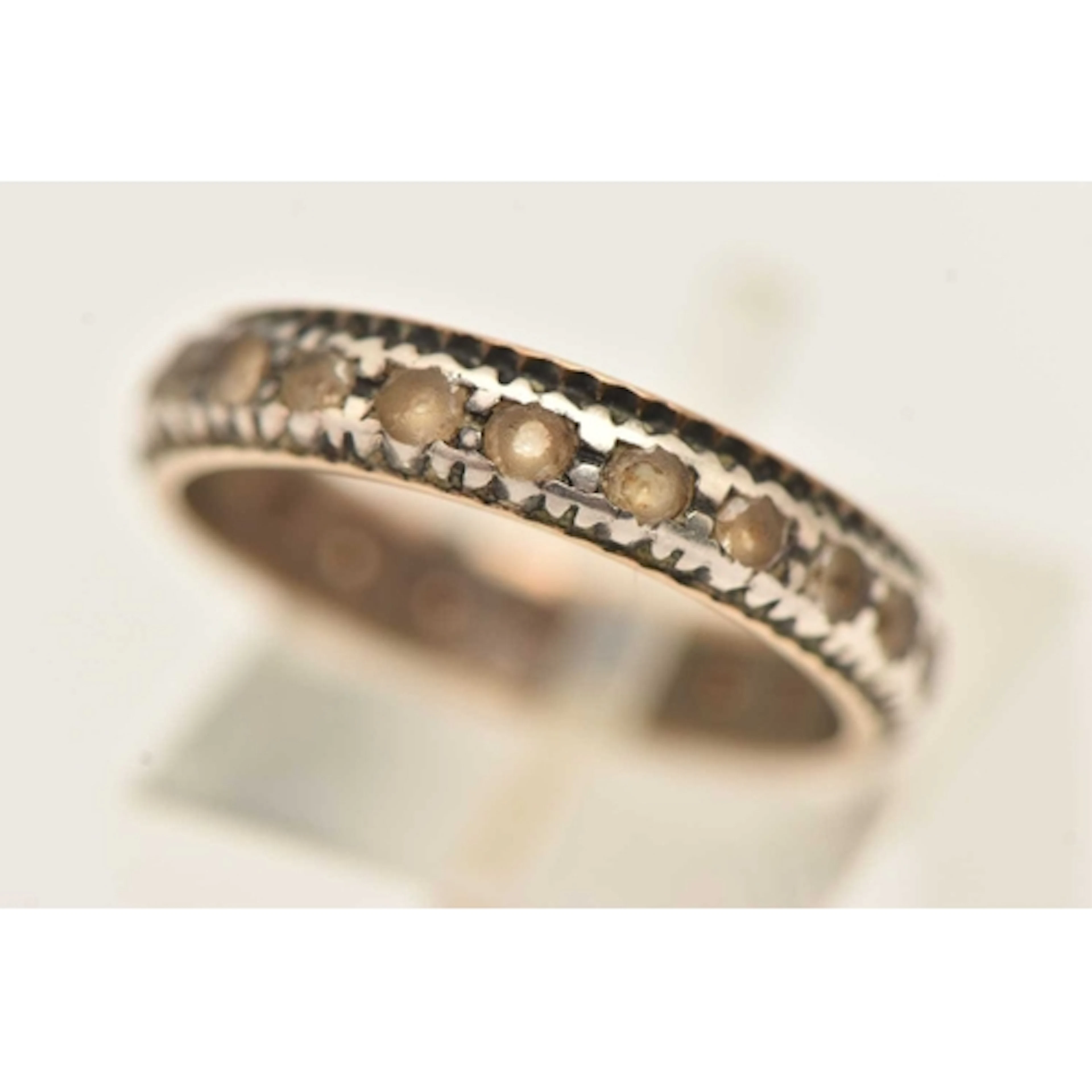 A BI-COLOUR ETERNITY RING, a yellow and white metal band rin...